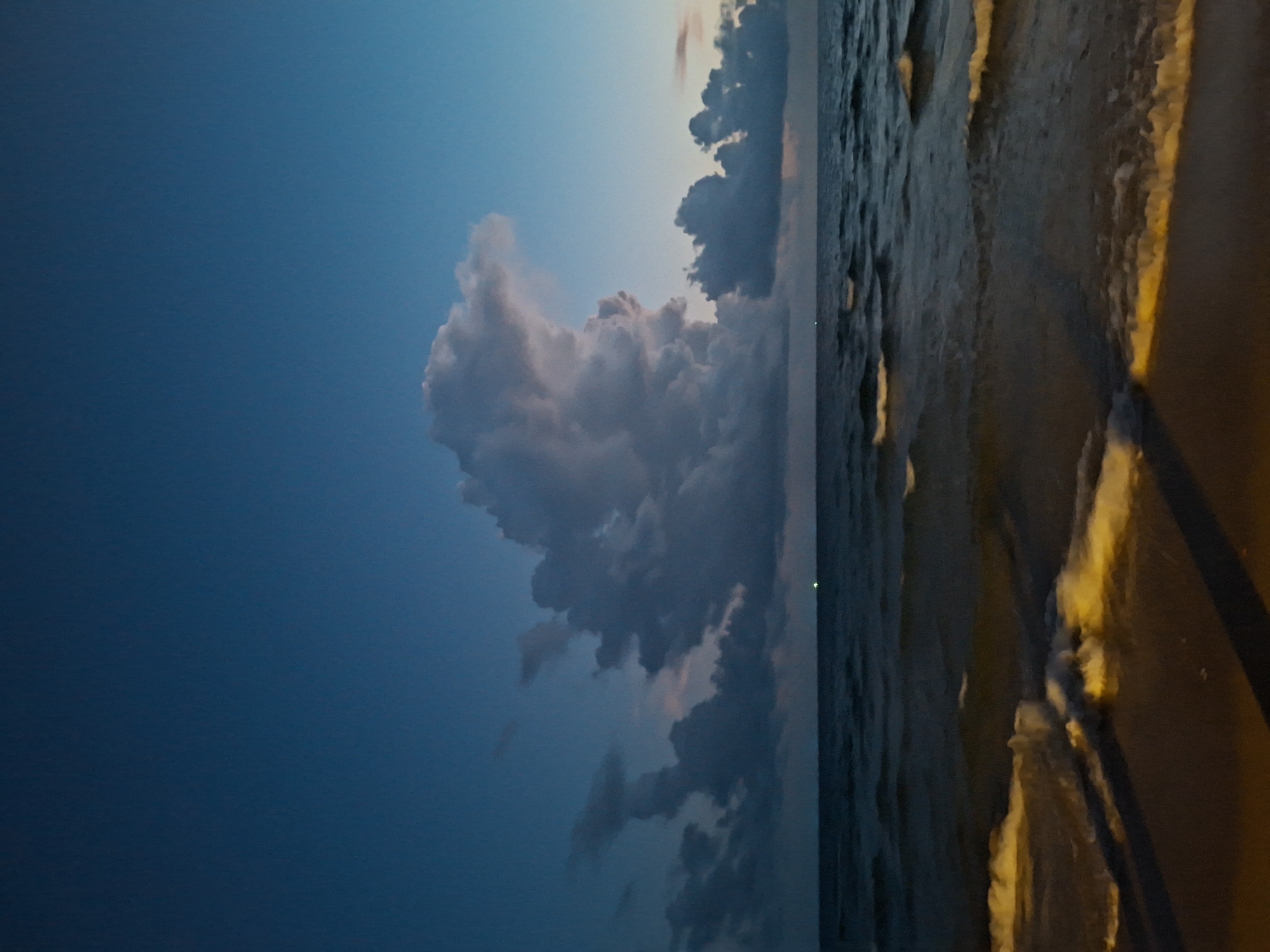 Beach at dusk through nightfall, moon rising over the ocean