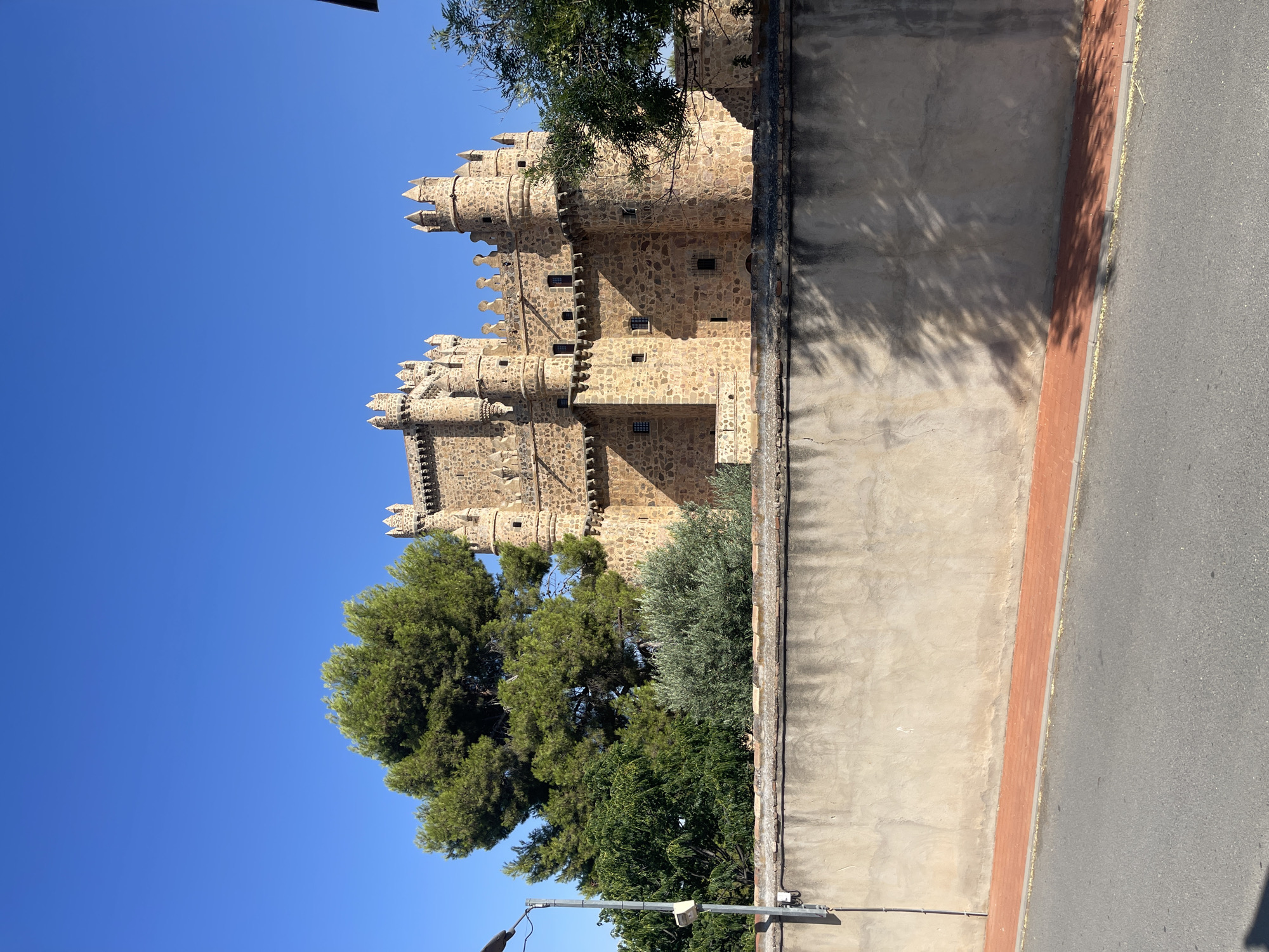 Guadamur's medieval castle, church, and chapel on a clear morning