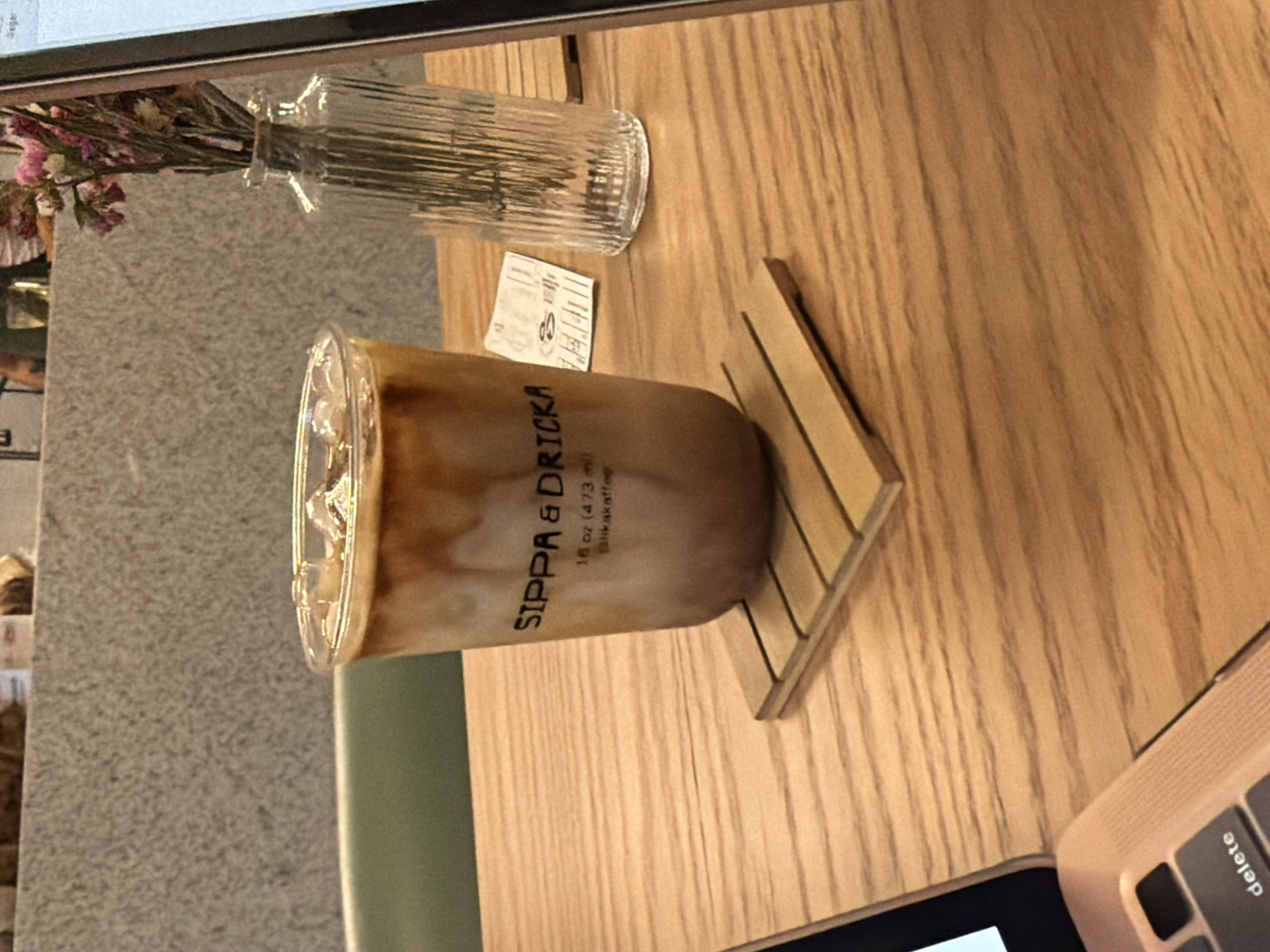 Laptop and iced coffee documented at unidentified cafe location