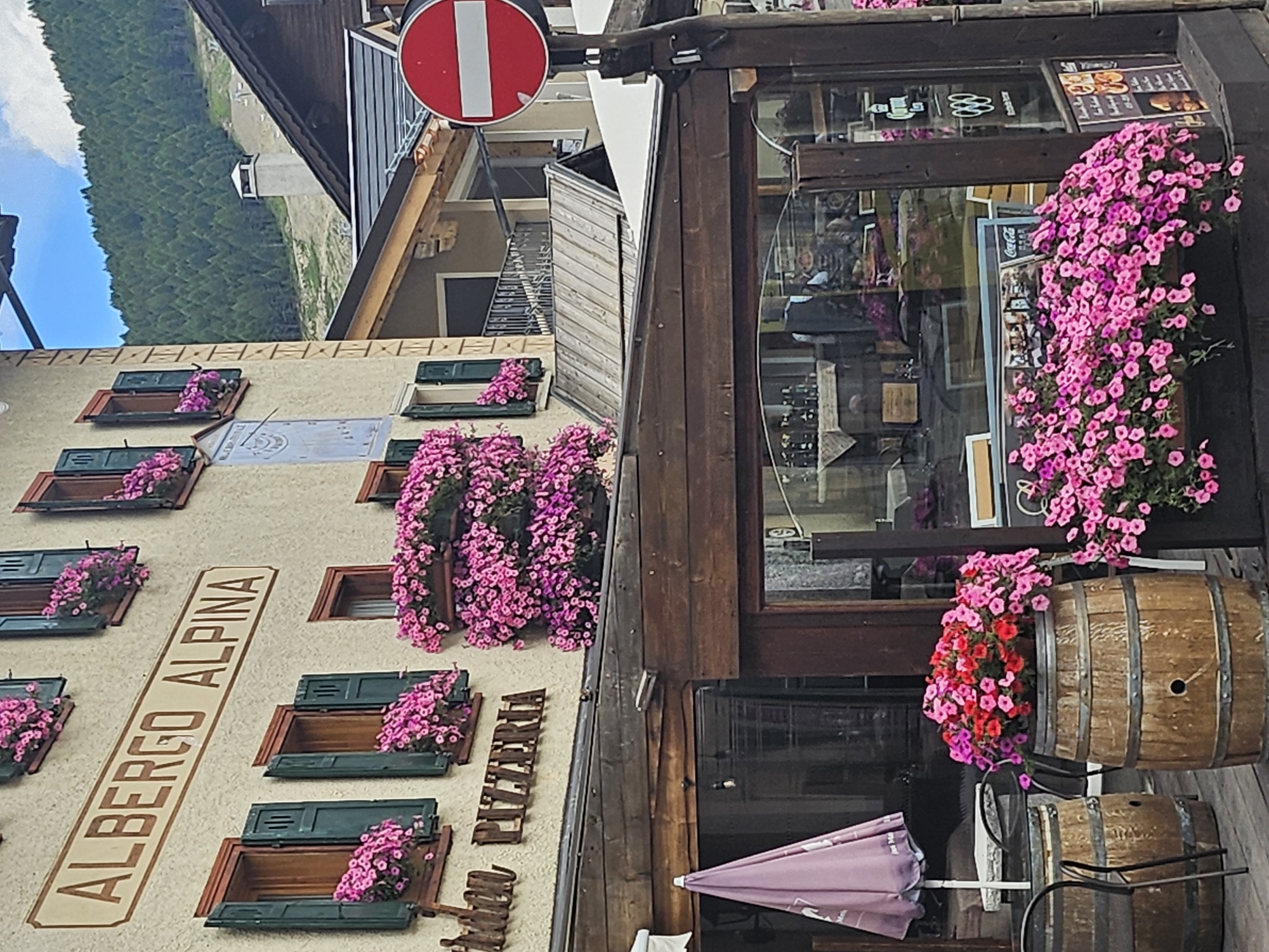 Alpine architecture and flower-lined facades along Livigno's main street