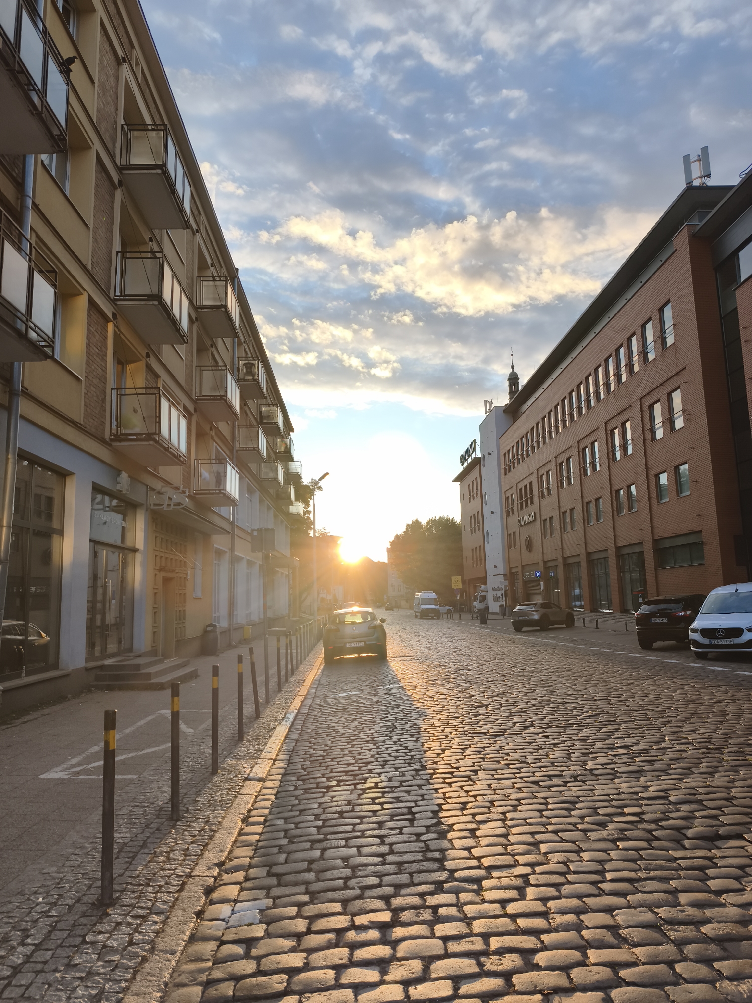 Gdańsk at golden hour, streets and station glowing at dusk
