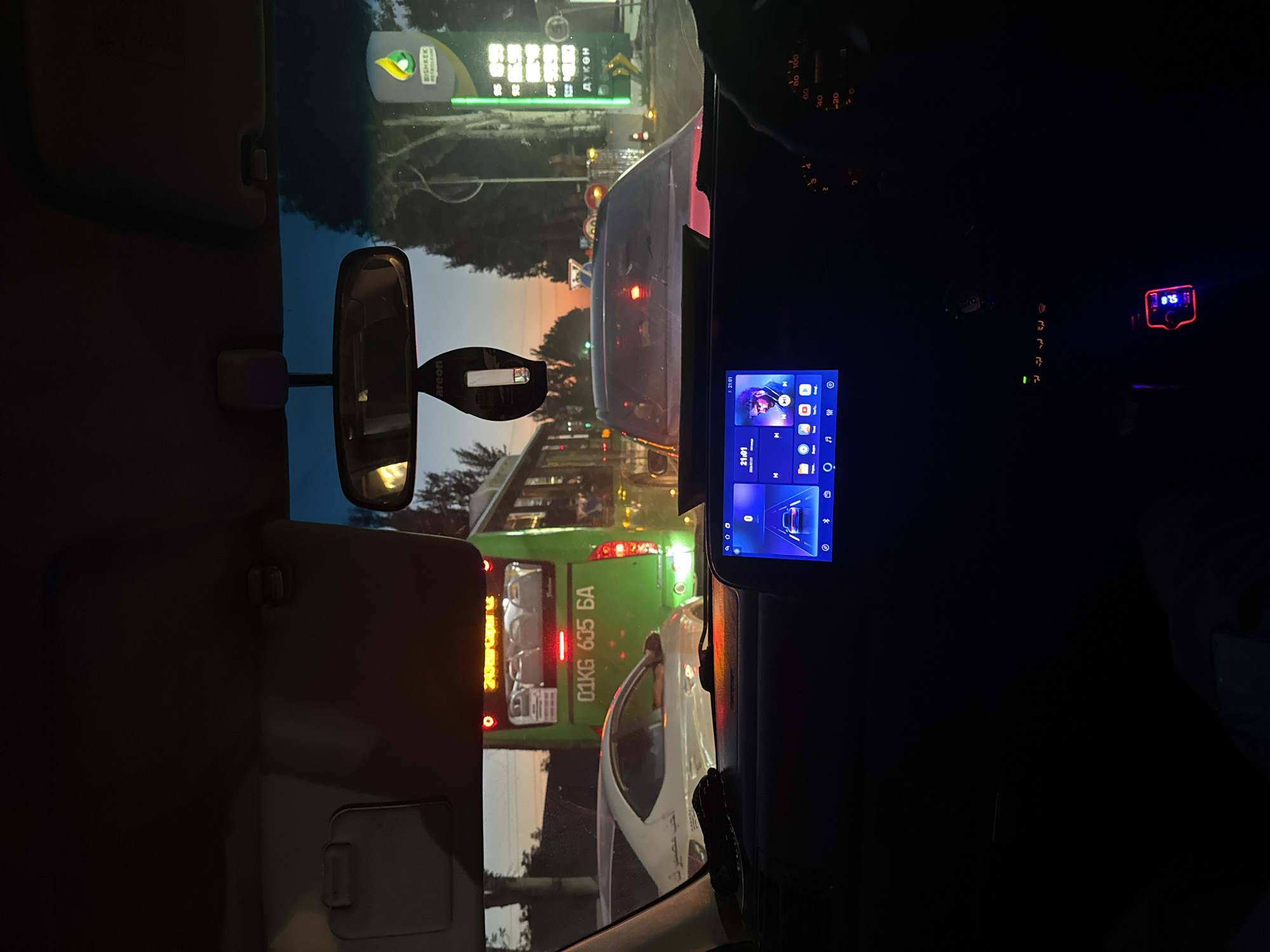 Evening drive through Bishkek traffic, dashboard view