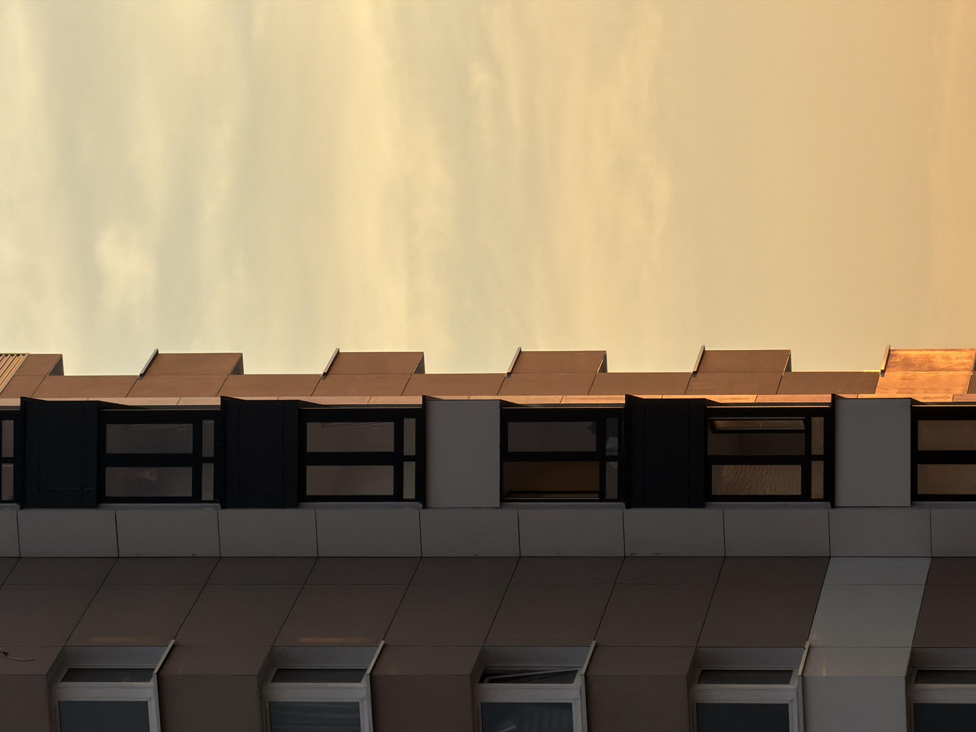 Homyel residential streets and rooftops at golden-hour sunset