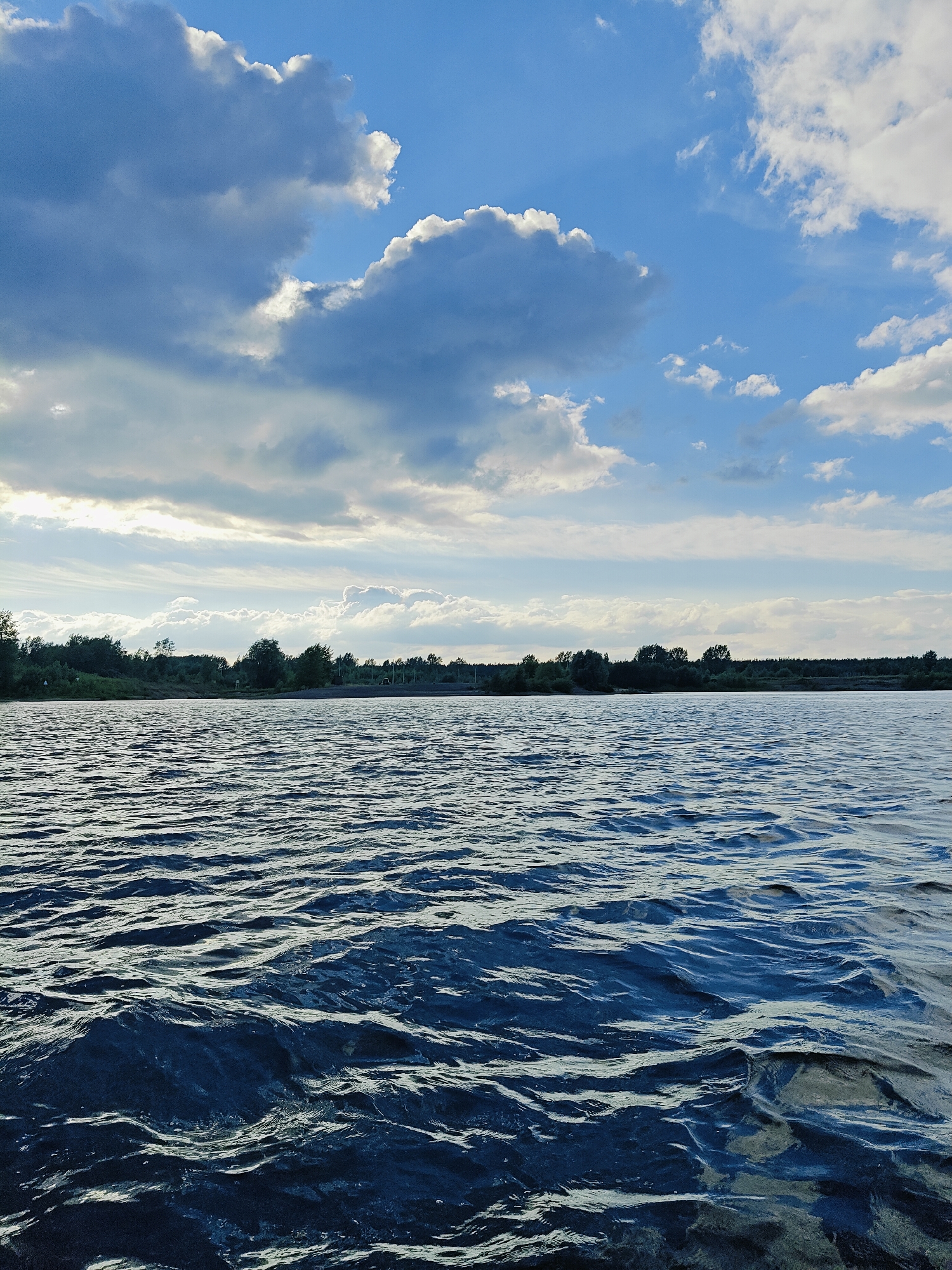 Boat trip on a wide Russian river with forested bluffs