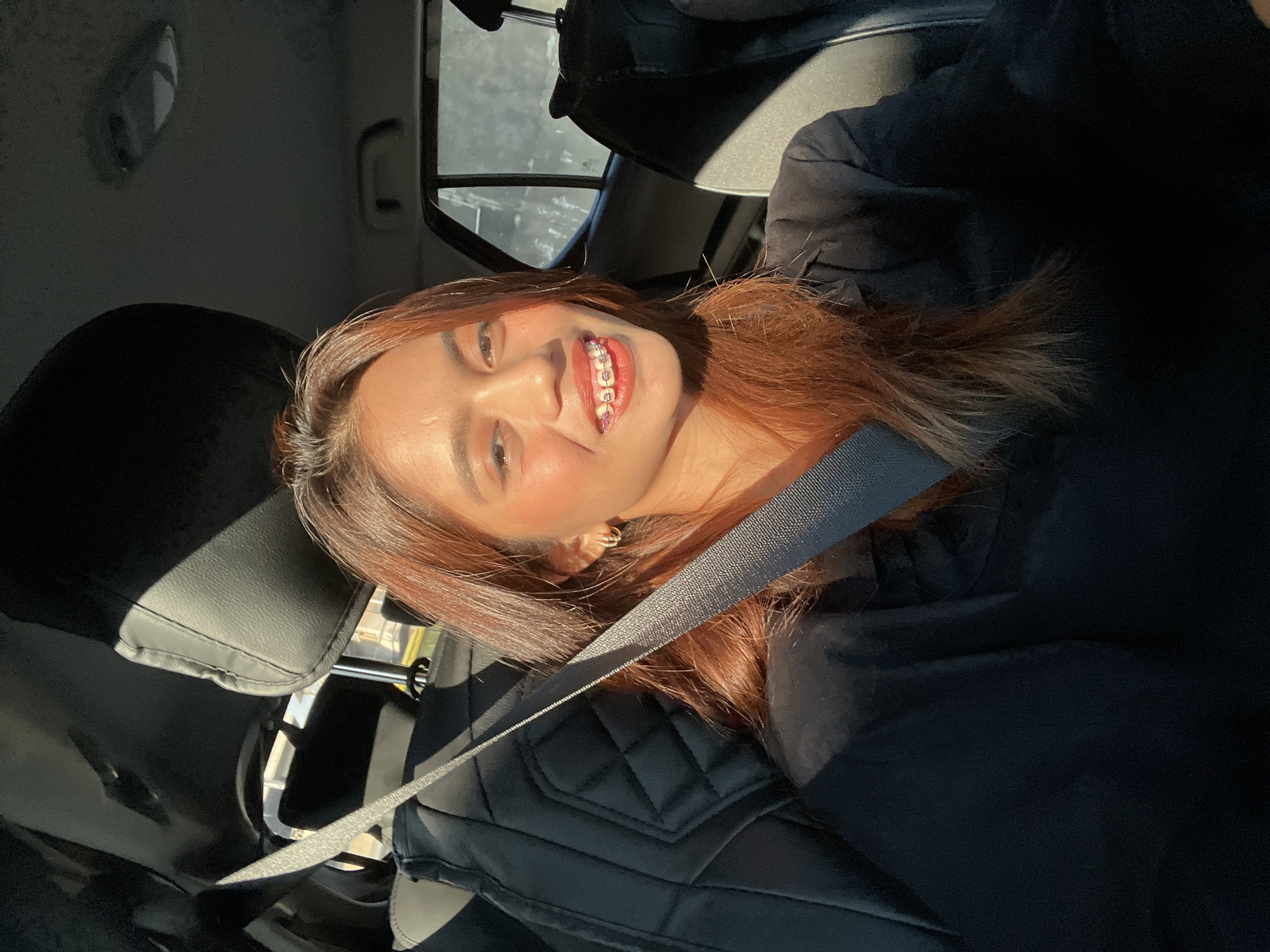 Woman takes selfies in car during morning drive