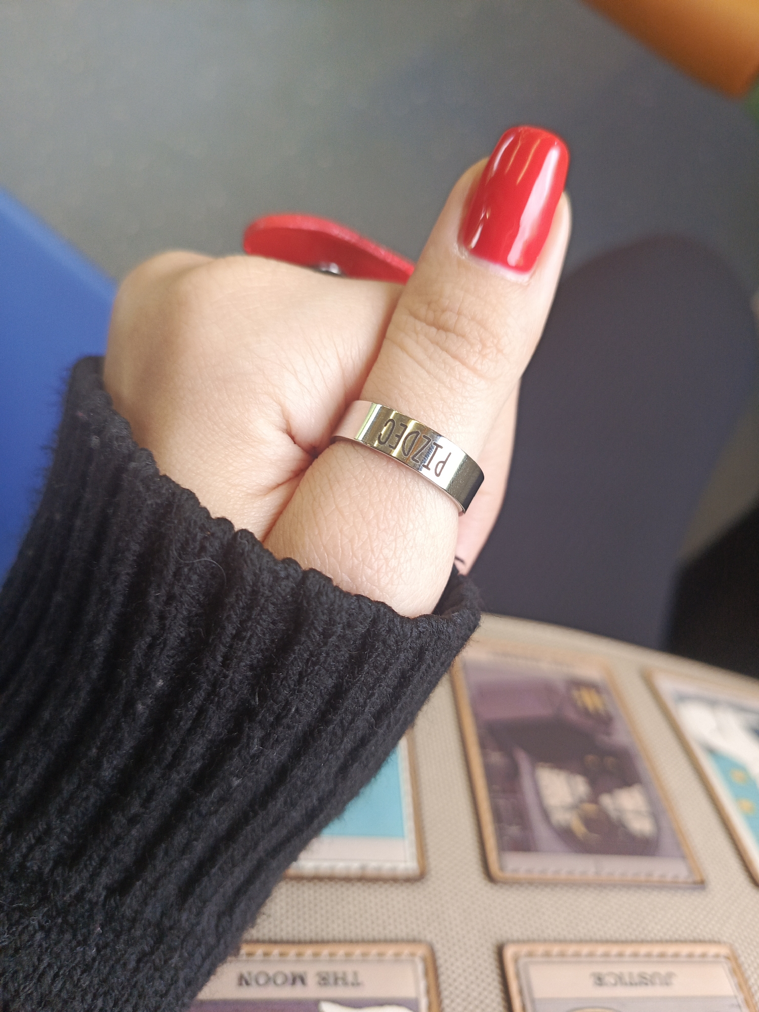 Train passenger displays distinctive jewelry and red nails in Russia