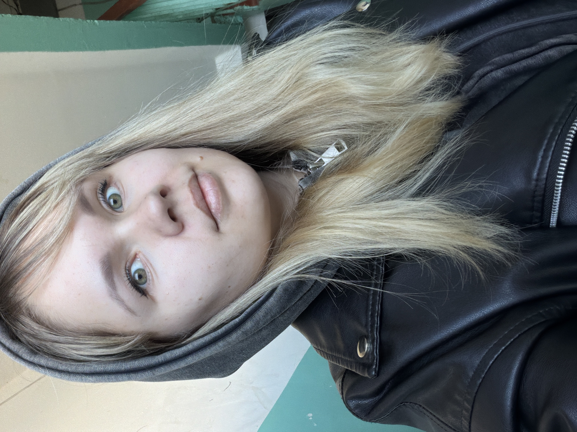 Upside-down portrait of young blonde person photographed early morning