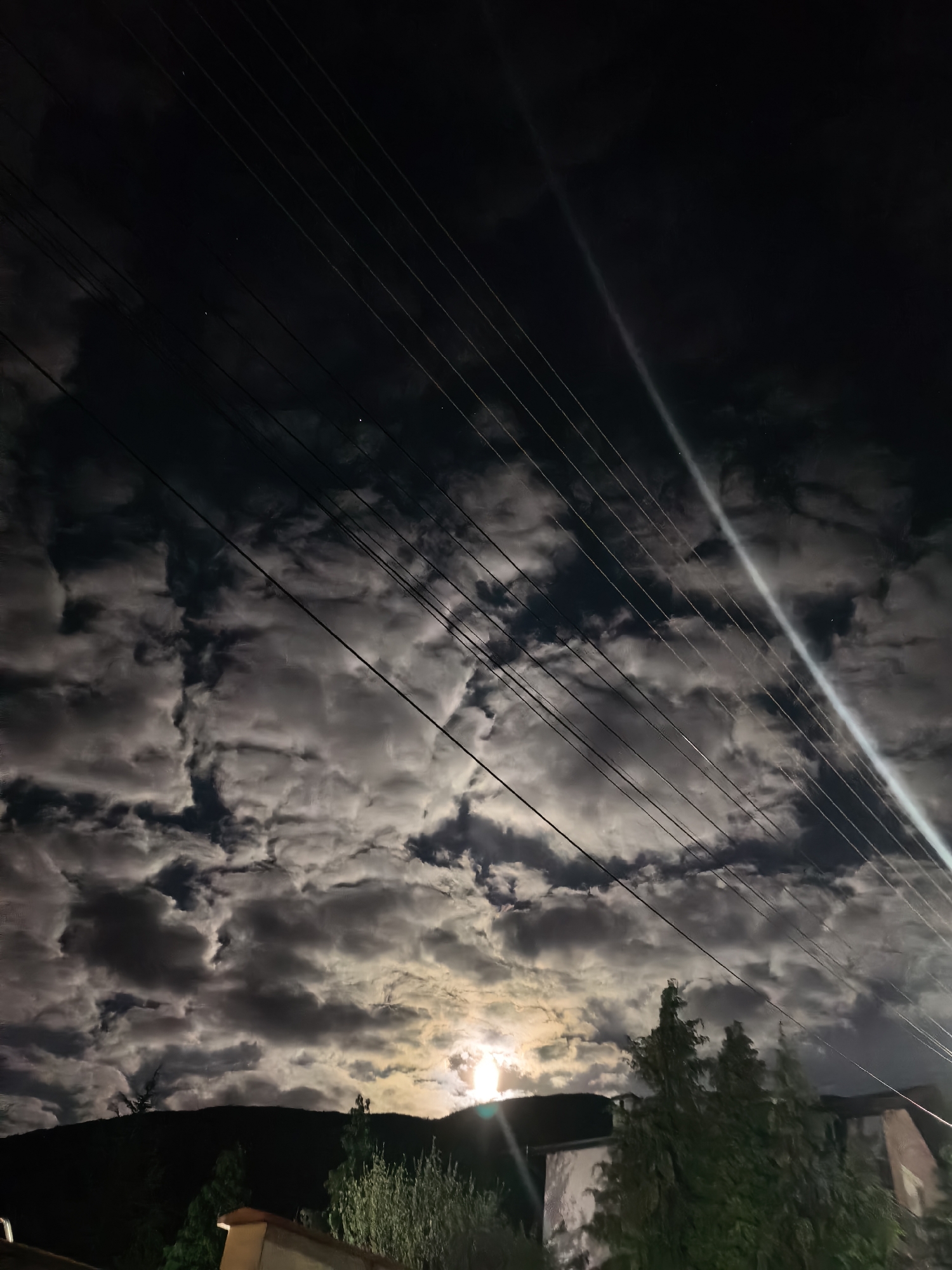 Bright clouds illuminate night sky over Sapareva Banya, Bulgaria