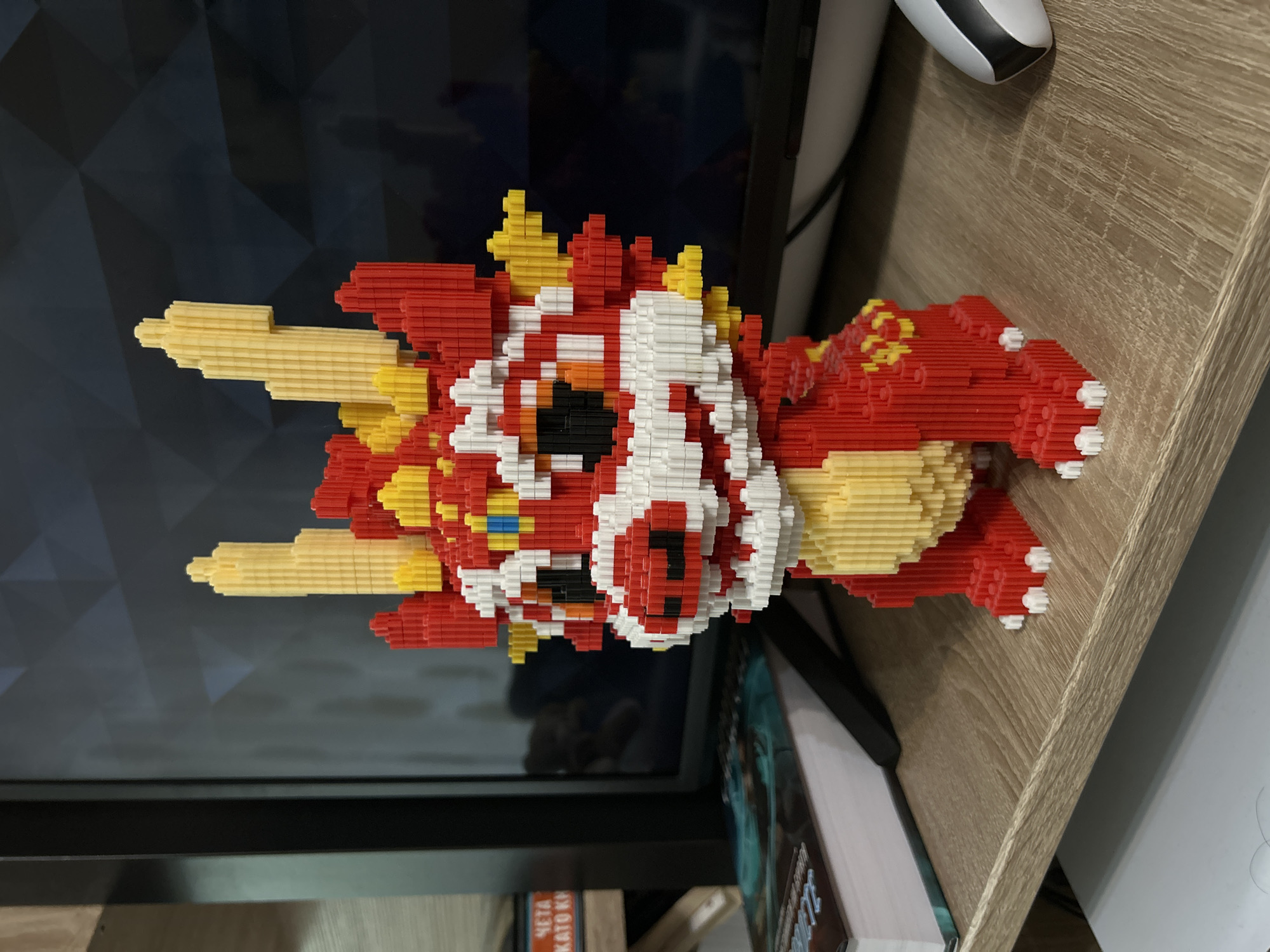 Colorful Lego dragon model spotted on wooden surface