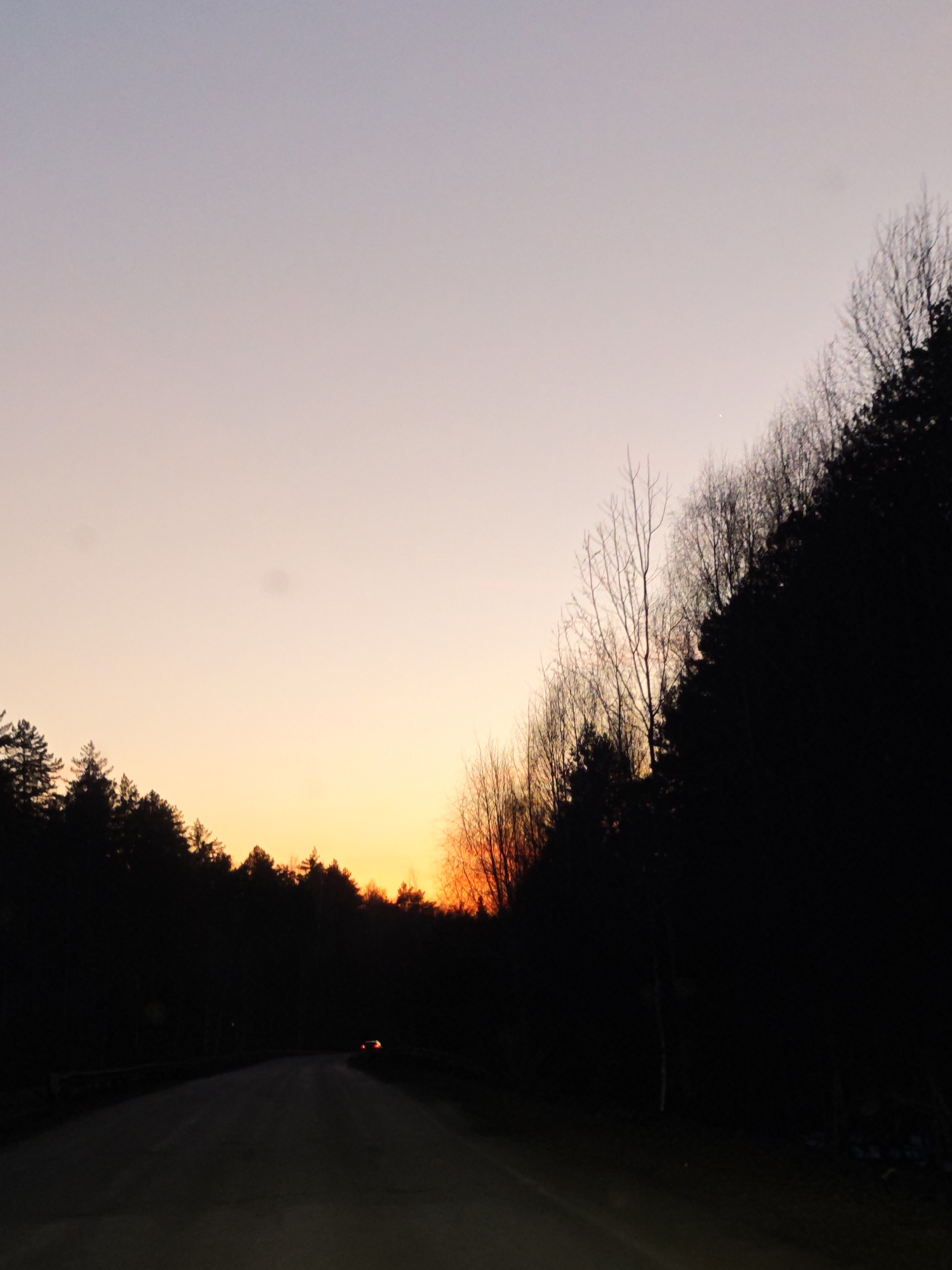 Women in car and twilight road scene in Dubovaya