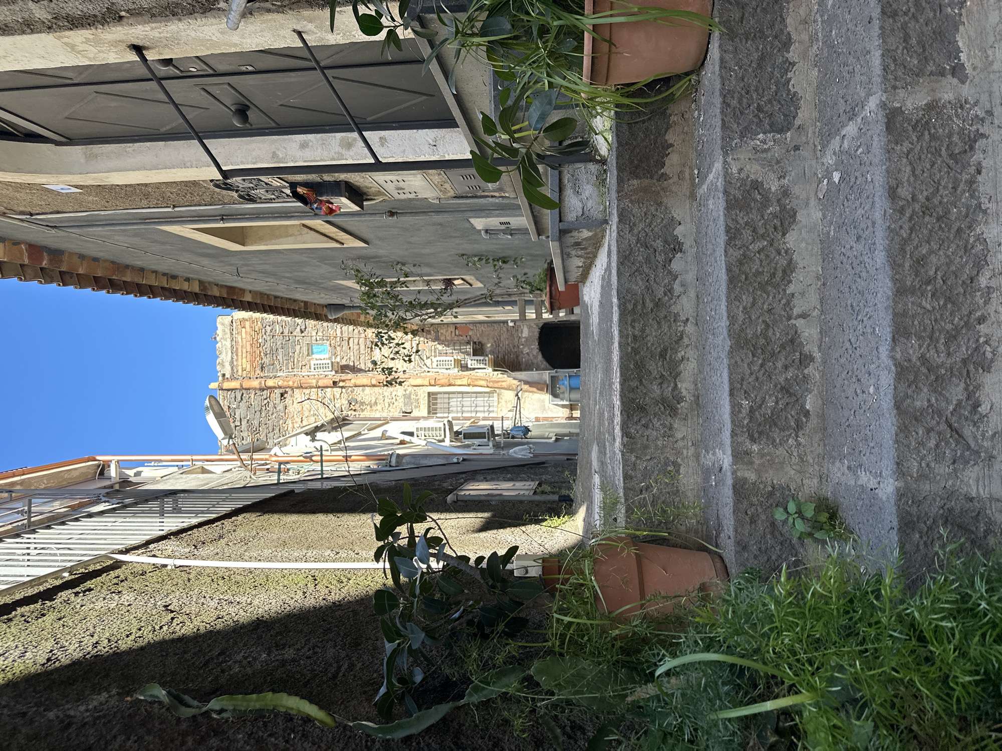Tourist documents afternoon walk through historic Catania streets