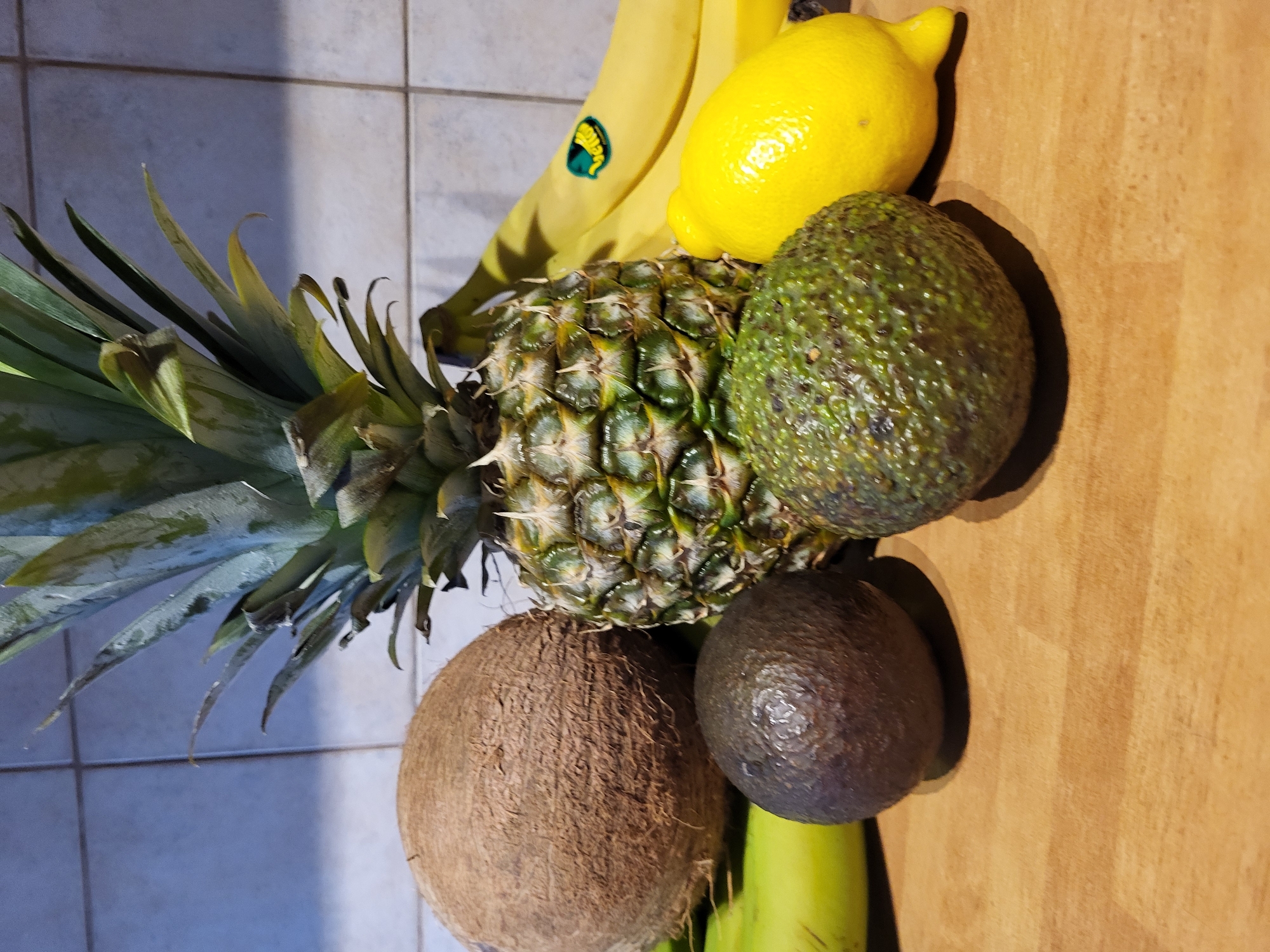 Kitchen tropical fruit prep session with coconut and pineapple