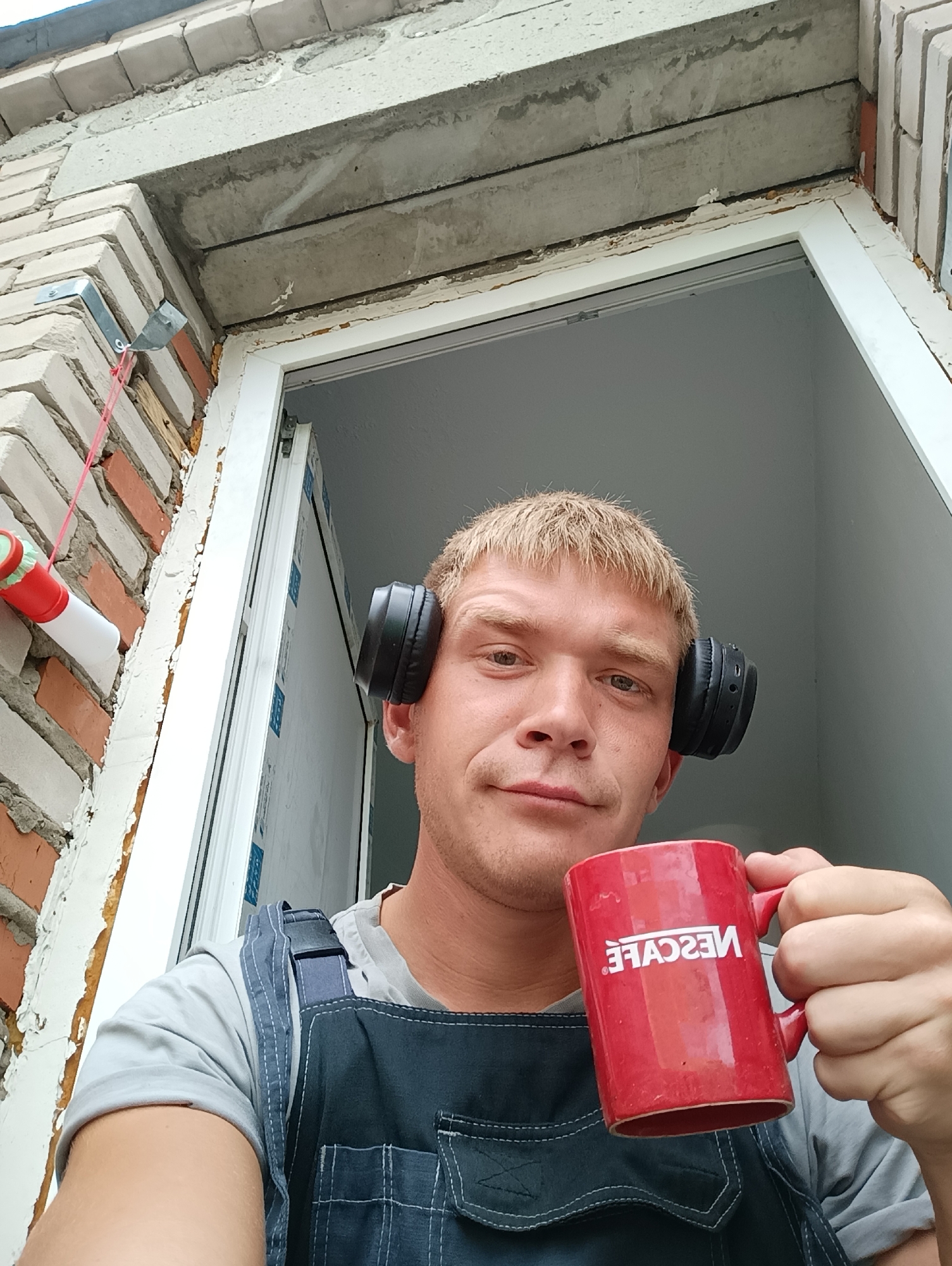 Blonde man in headphones captured in rooftop photo session