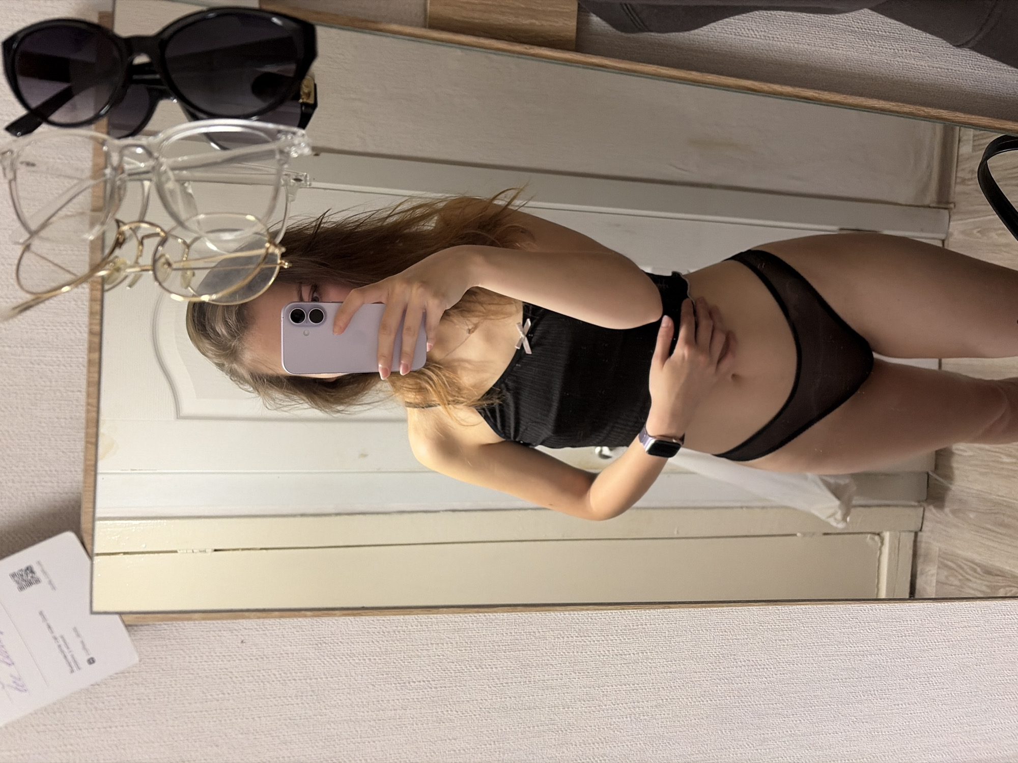 Mirror selfie in Kyiv changing room, black lingerie with ruffle detail.
