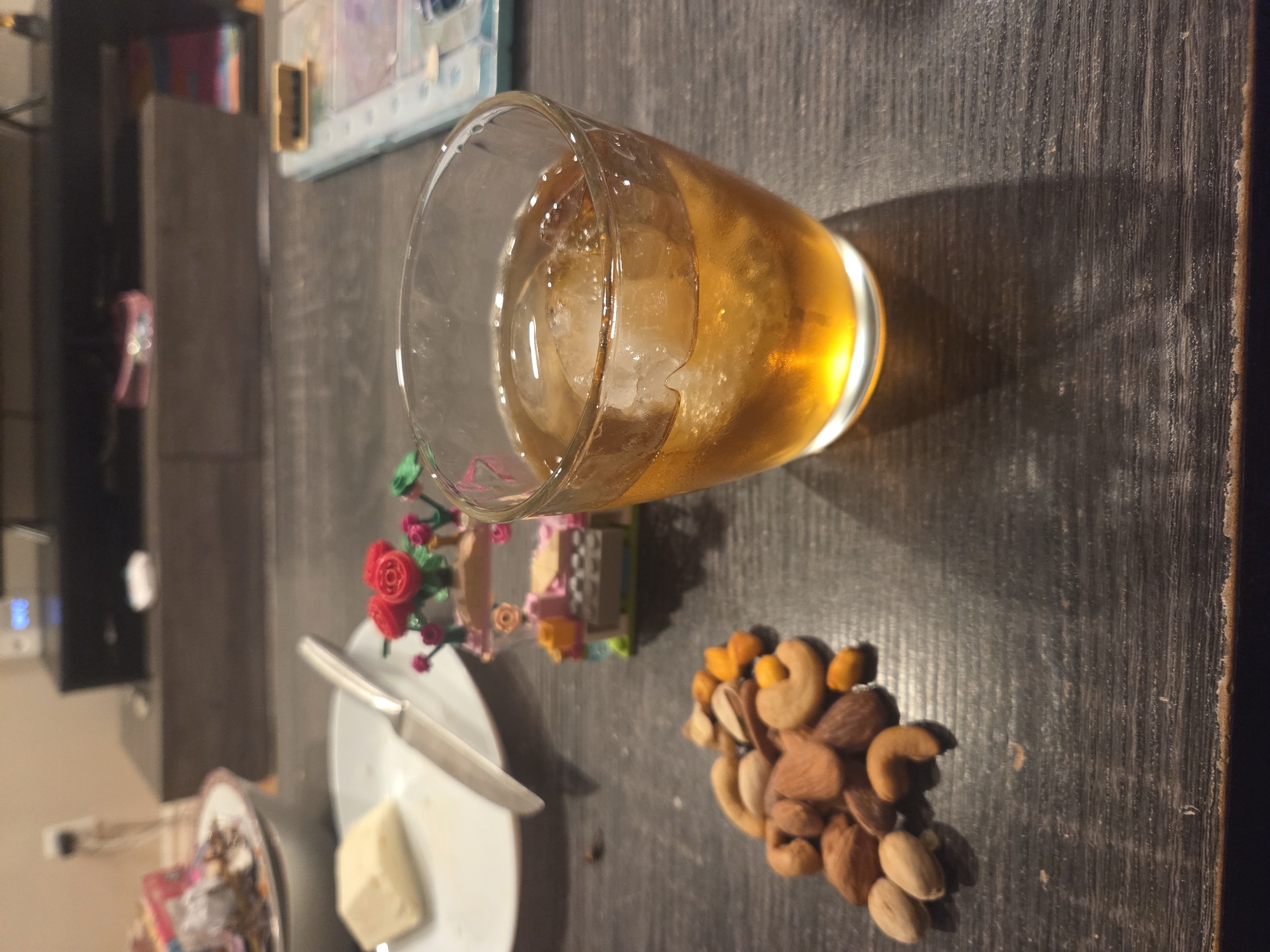 Evening table scene with amber beverage captured indoors