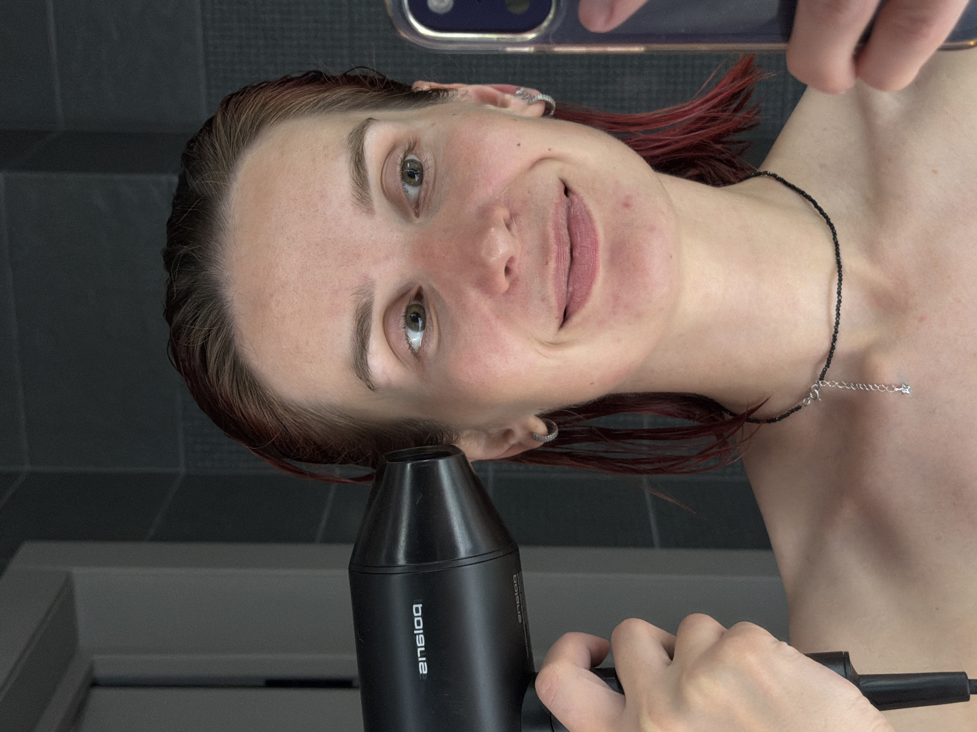 Woman Takes Bathroom Selfies While Drying Hair in Chaikovsky