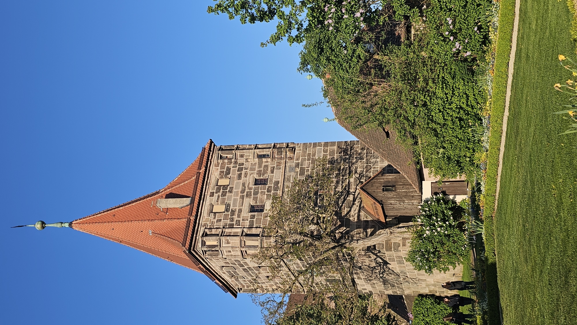 Visitor documents Nuremberg Castle towers and gardens under clear skies