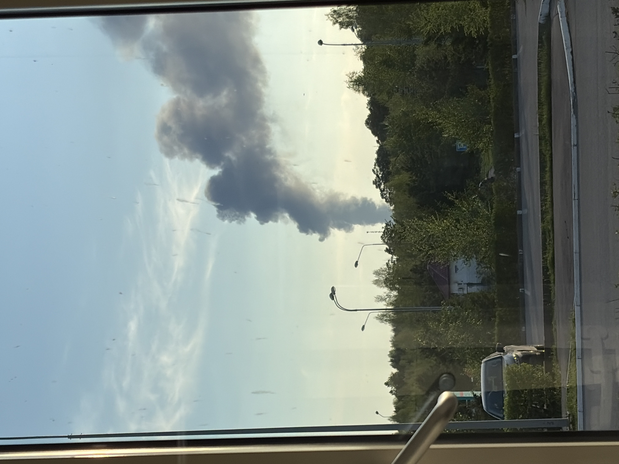 Dark smoke plume observed rising near residential area
