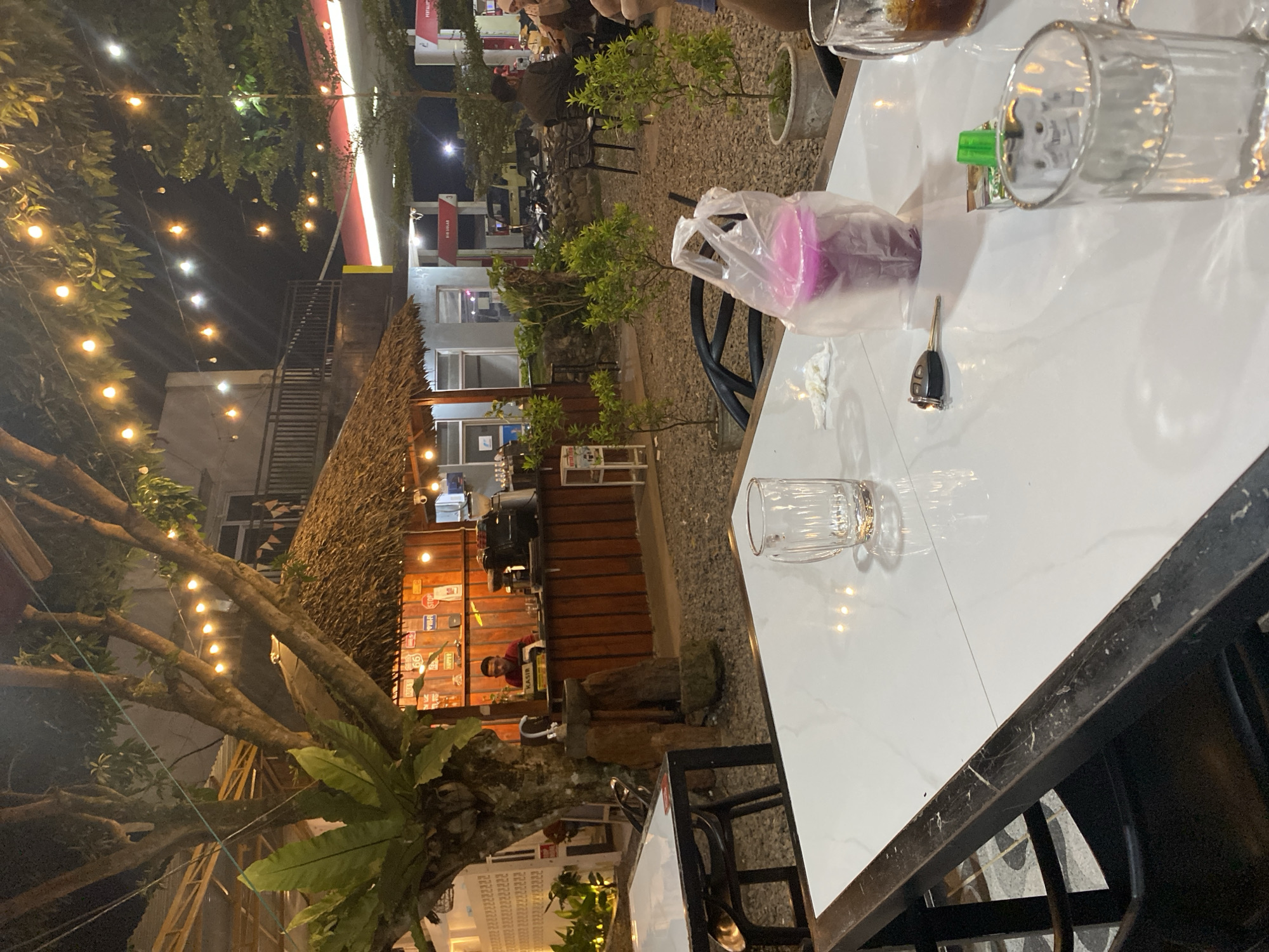Nighttime café hangout near a mosque in an urban setting