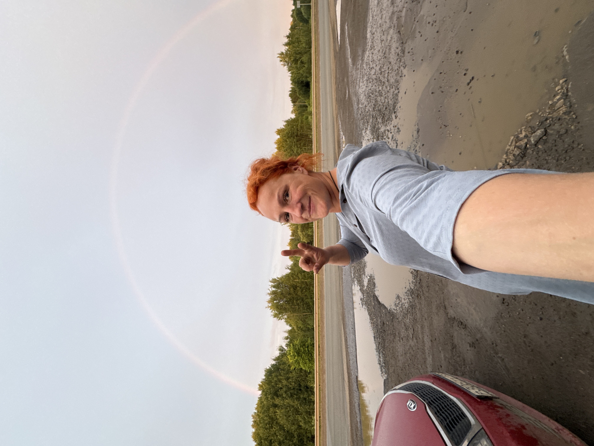 Double rainbow stops roadside group in rural Russia