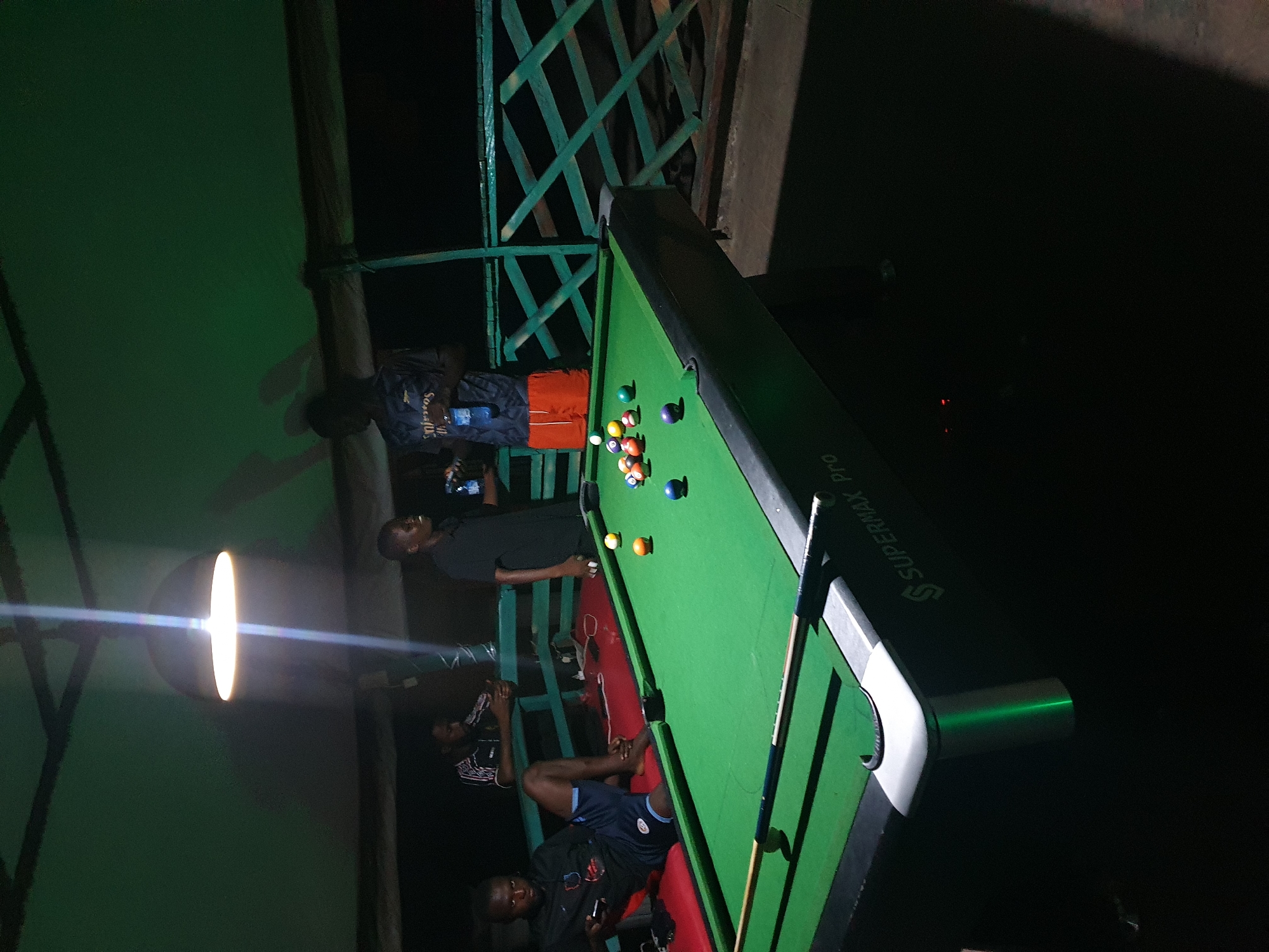 Evening pool game at outdoor recreational spot in Lokoja