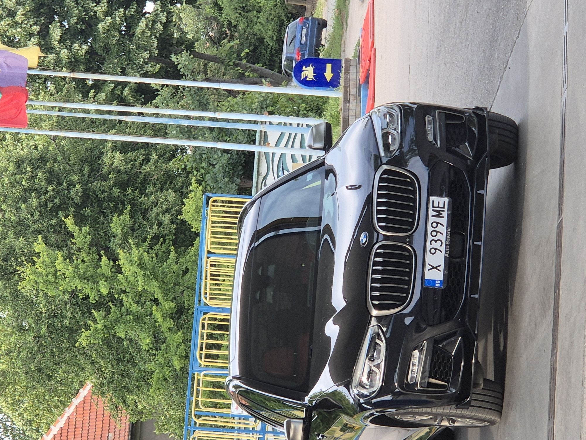 Mixed urban observations: BMW, TV footage, energy drinks, formal couple