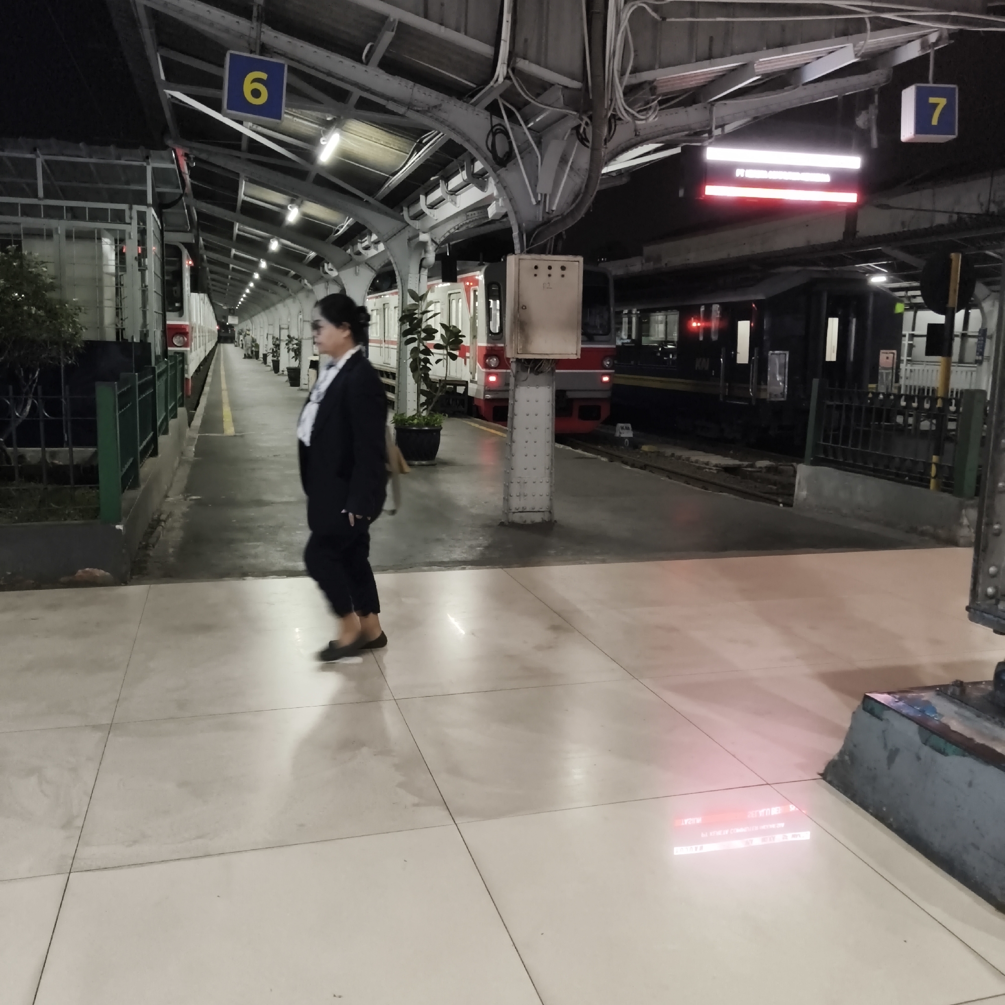 West Jakarta commuter rail station at night, trains at platform