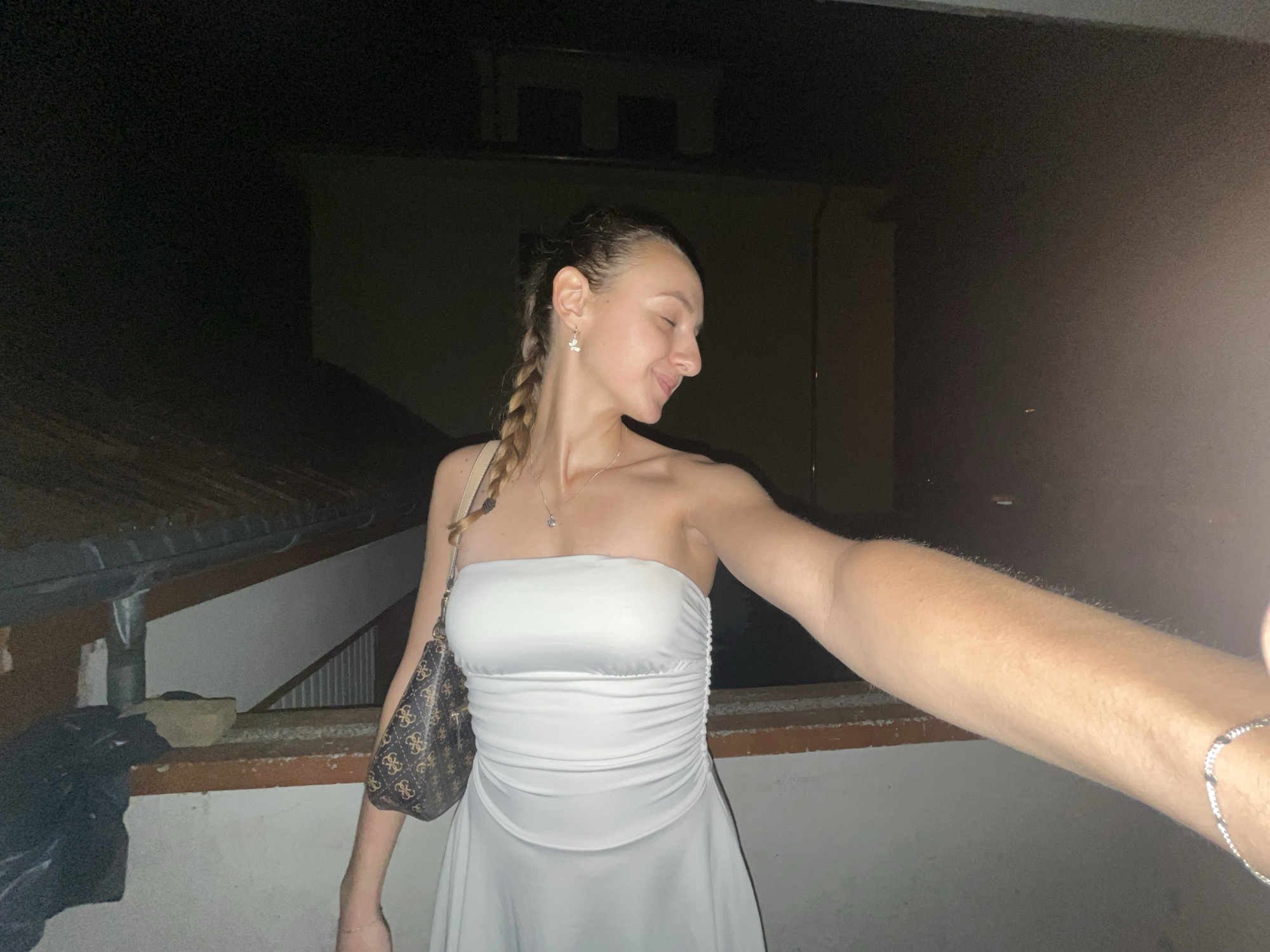 Woman takes nighttime selfies in white dress in Saarbrücken