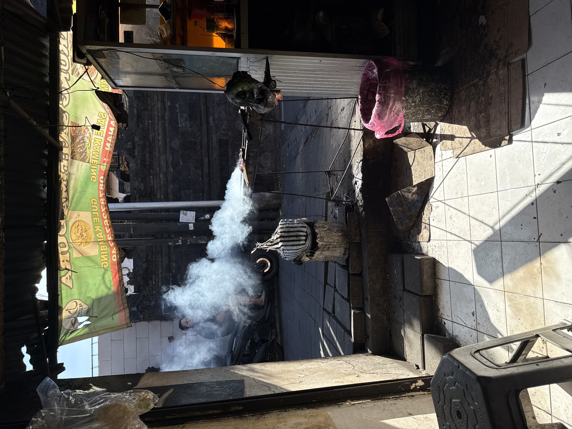 Street vendor cooks food from motorcycle setup in Kuta