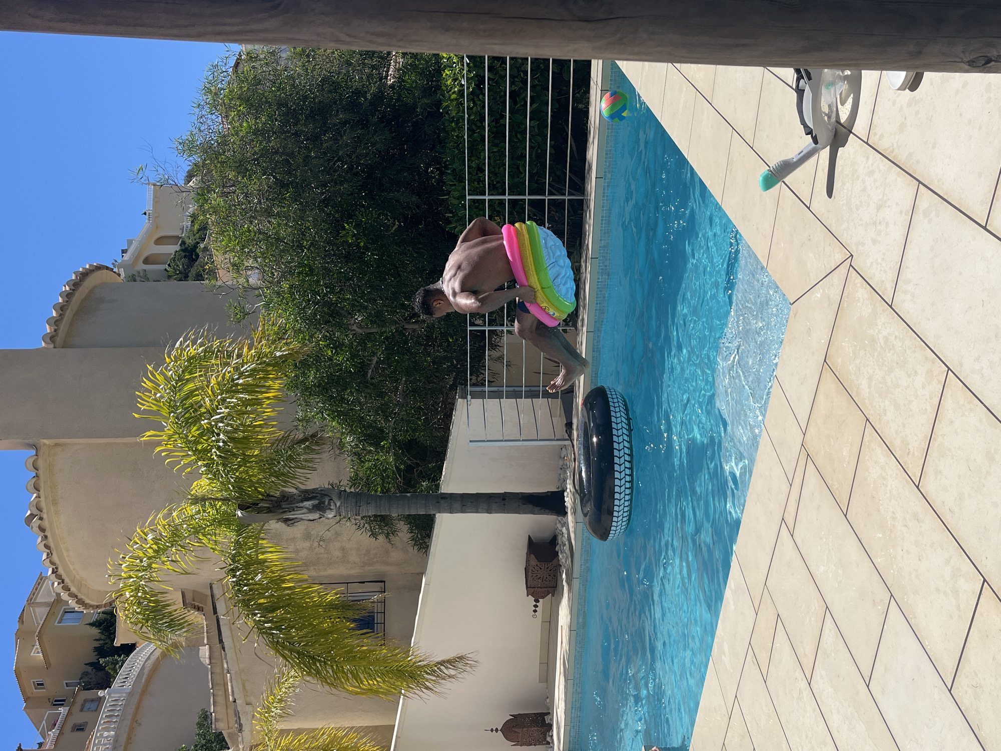 Man enjoys morning pool activities in Spanish coastal town