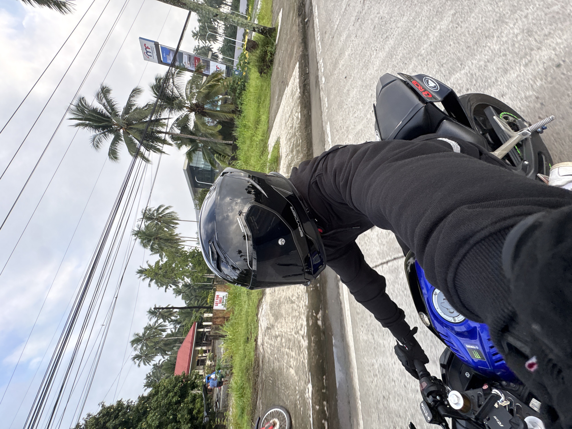 Evening motorcycle ride through palm-lined streets in Tagum City