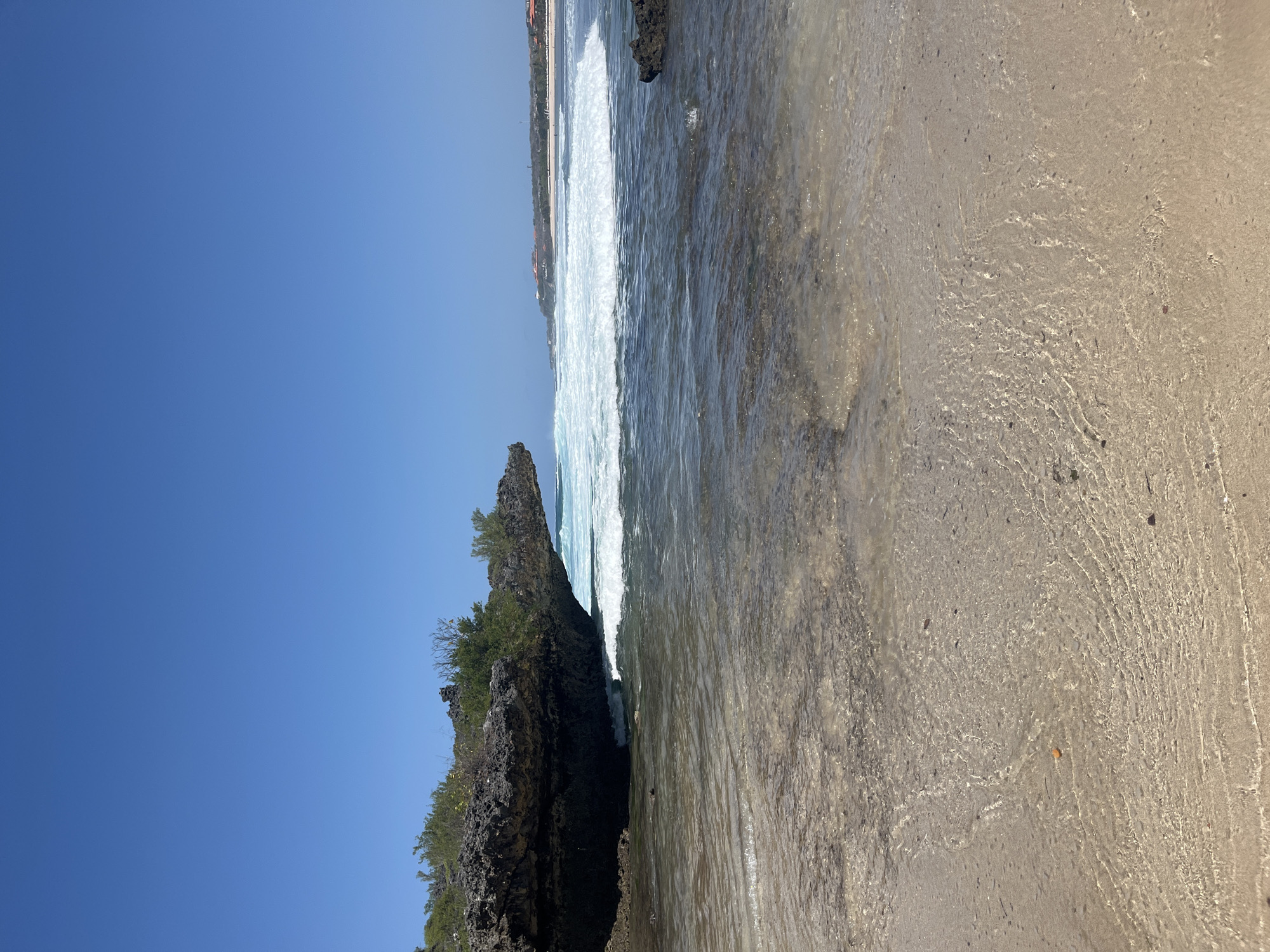 Sunny morning on a rocky, quiet beach in Kuta Selatan