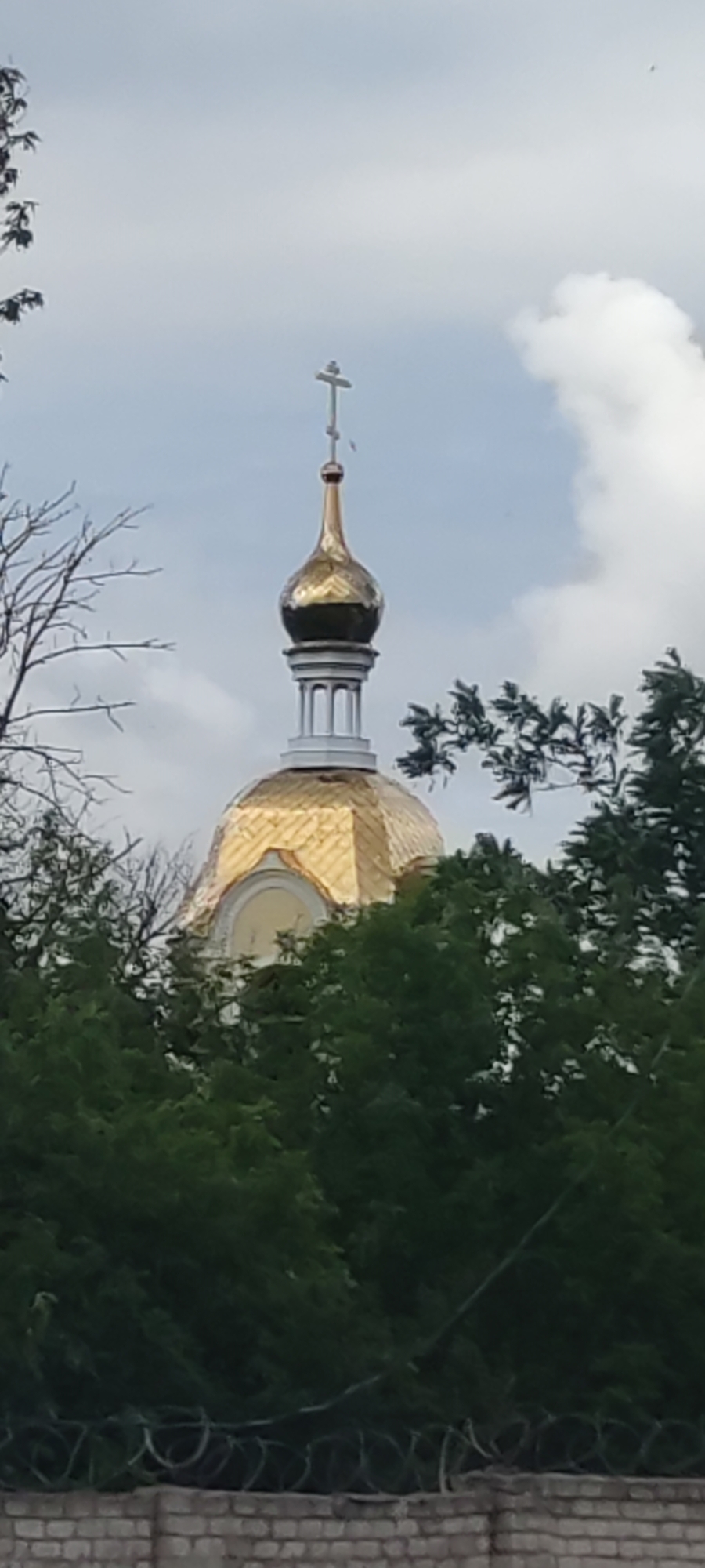Golden church dome, street lamppost, and accessible bus in one spot