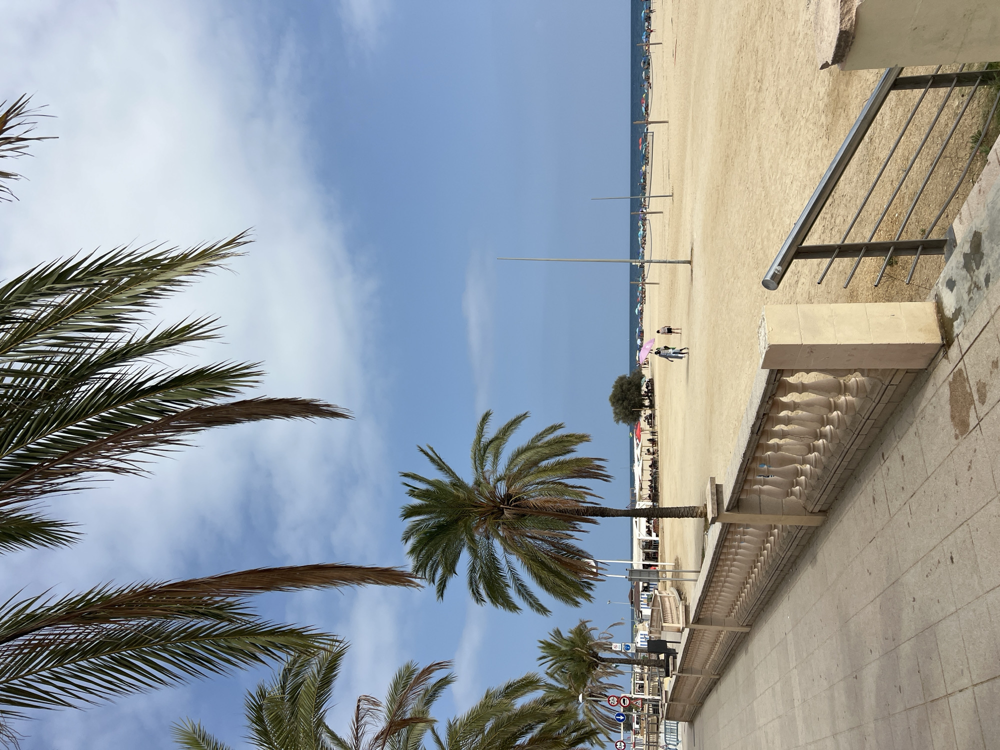 Beach promenade and clock tower in El Masnou on a sunny afternoon