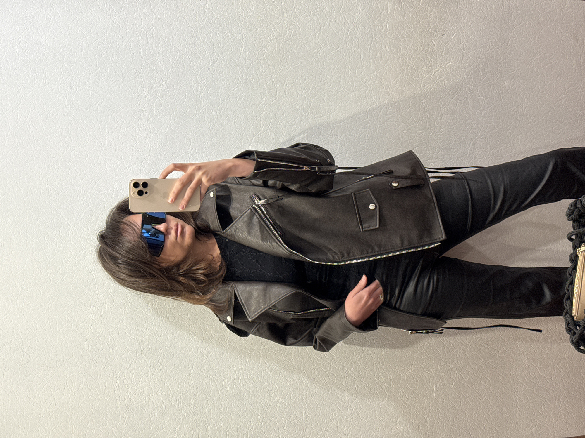 Person takes selfies in leather jacket, Krasnoyarsk