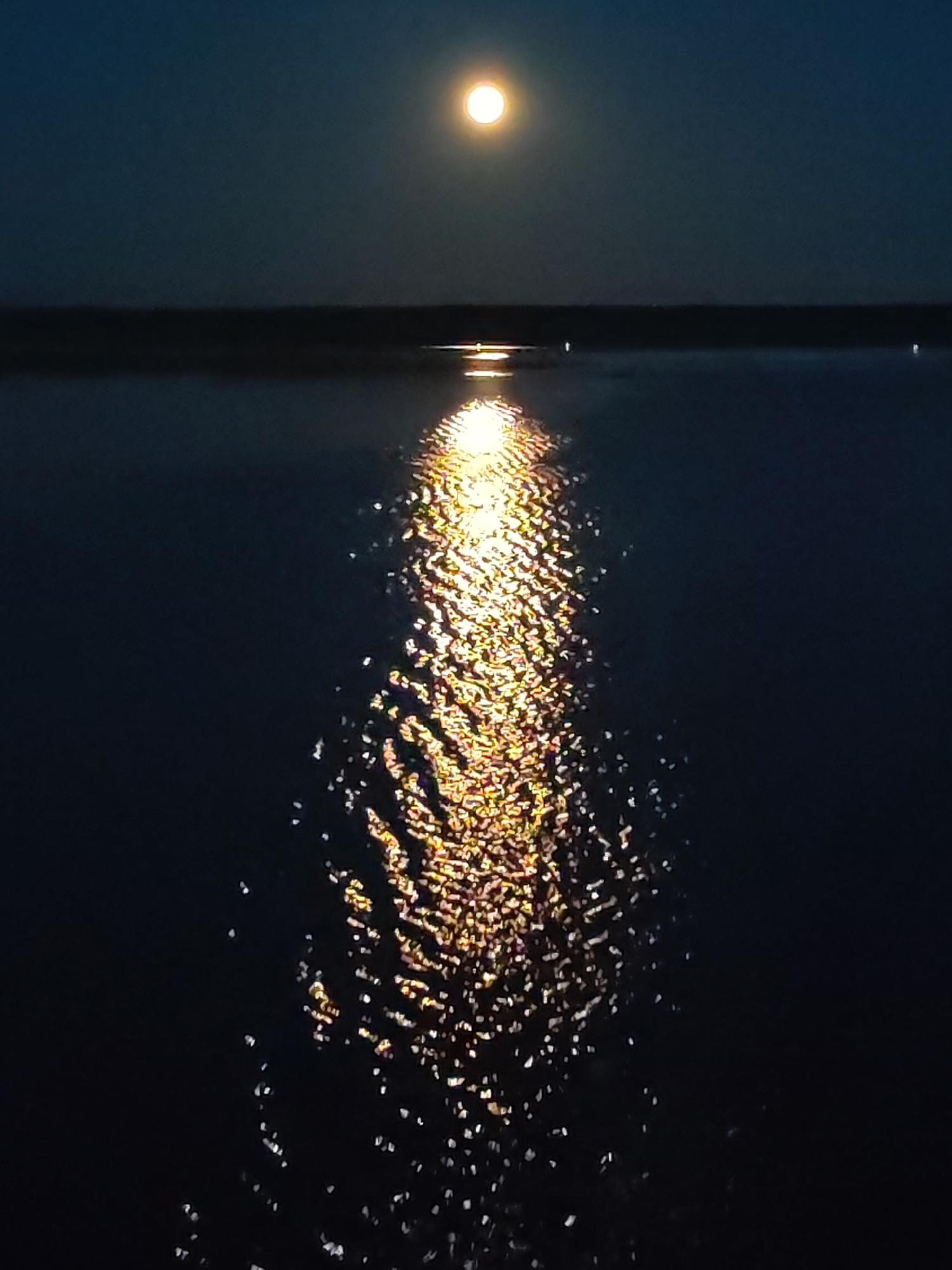 Moonlight creates golden reflection on Russian water body