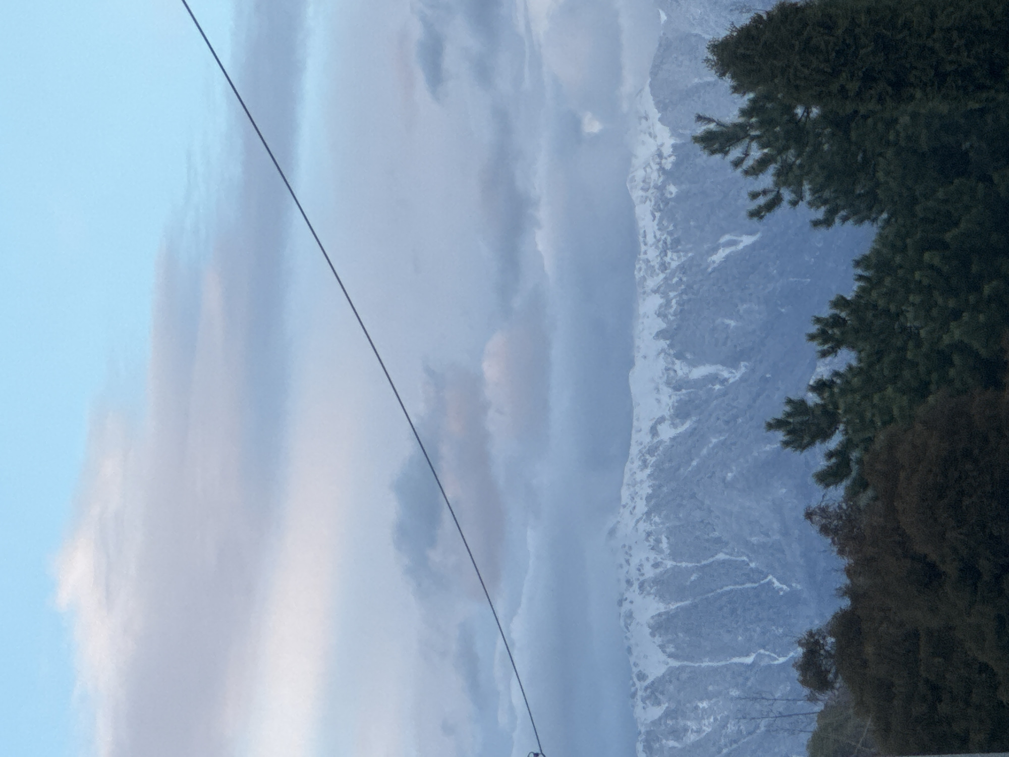 Power lines frame snowy mountain vista in Sirius, Russia