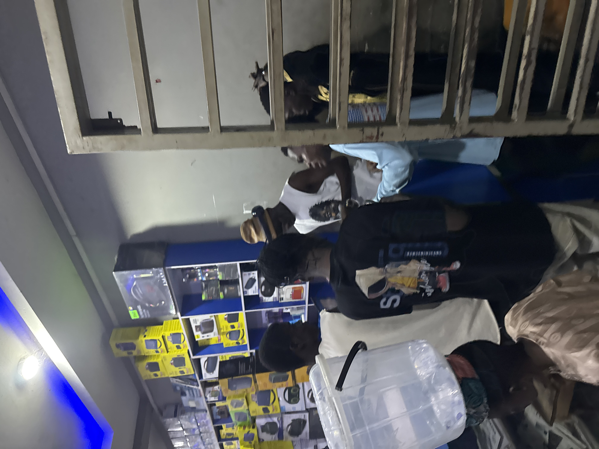 Electronics shop and street life in Jalingo at dusk