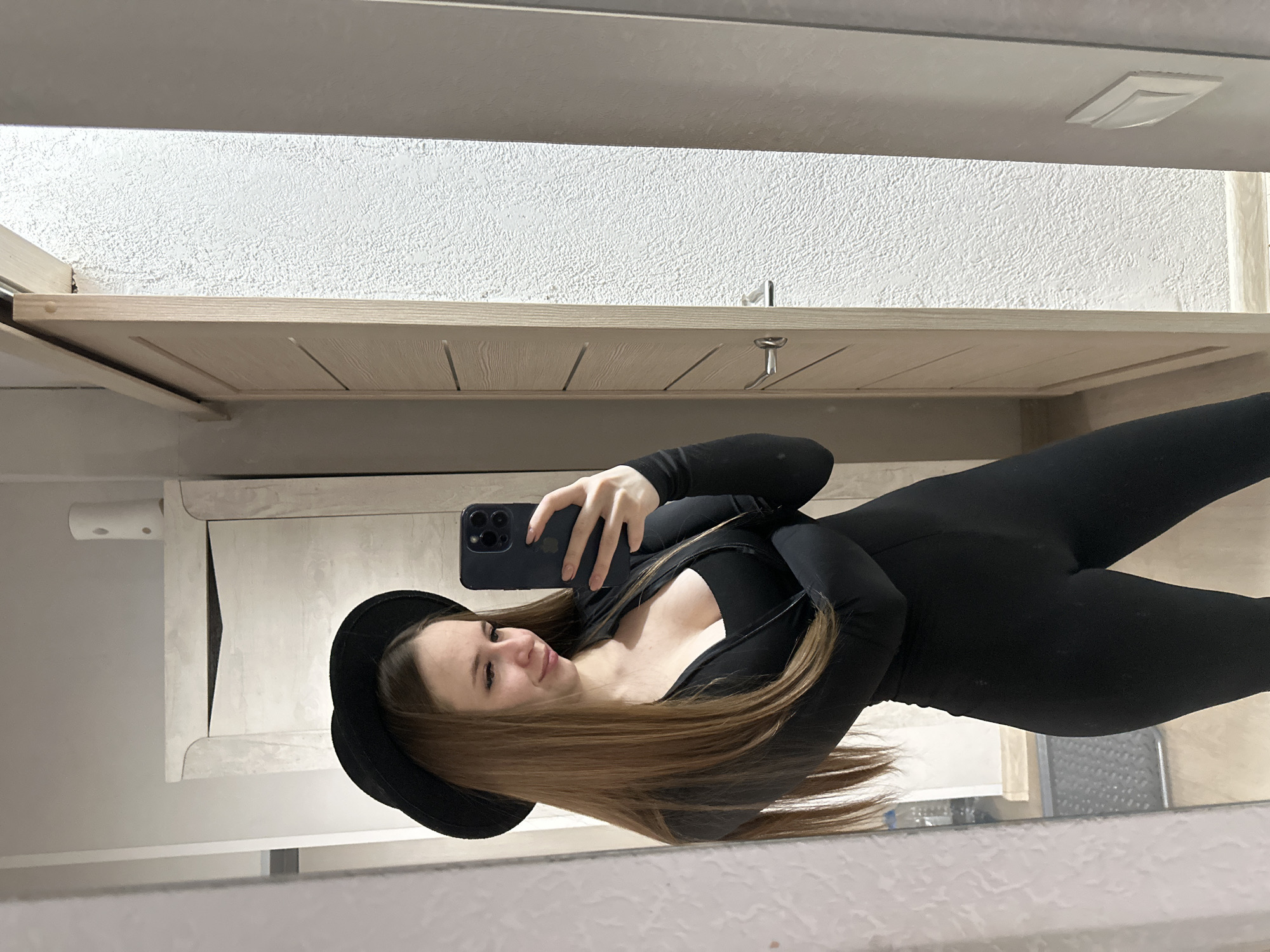 Woman Takes Multiple Mirror Selfies in Black Outfit Indoors