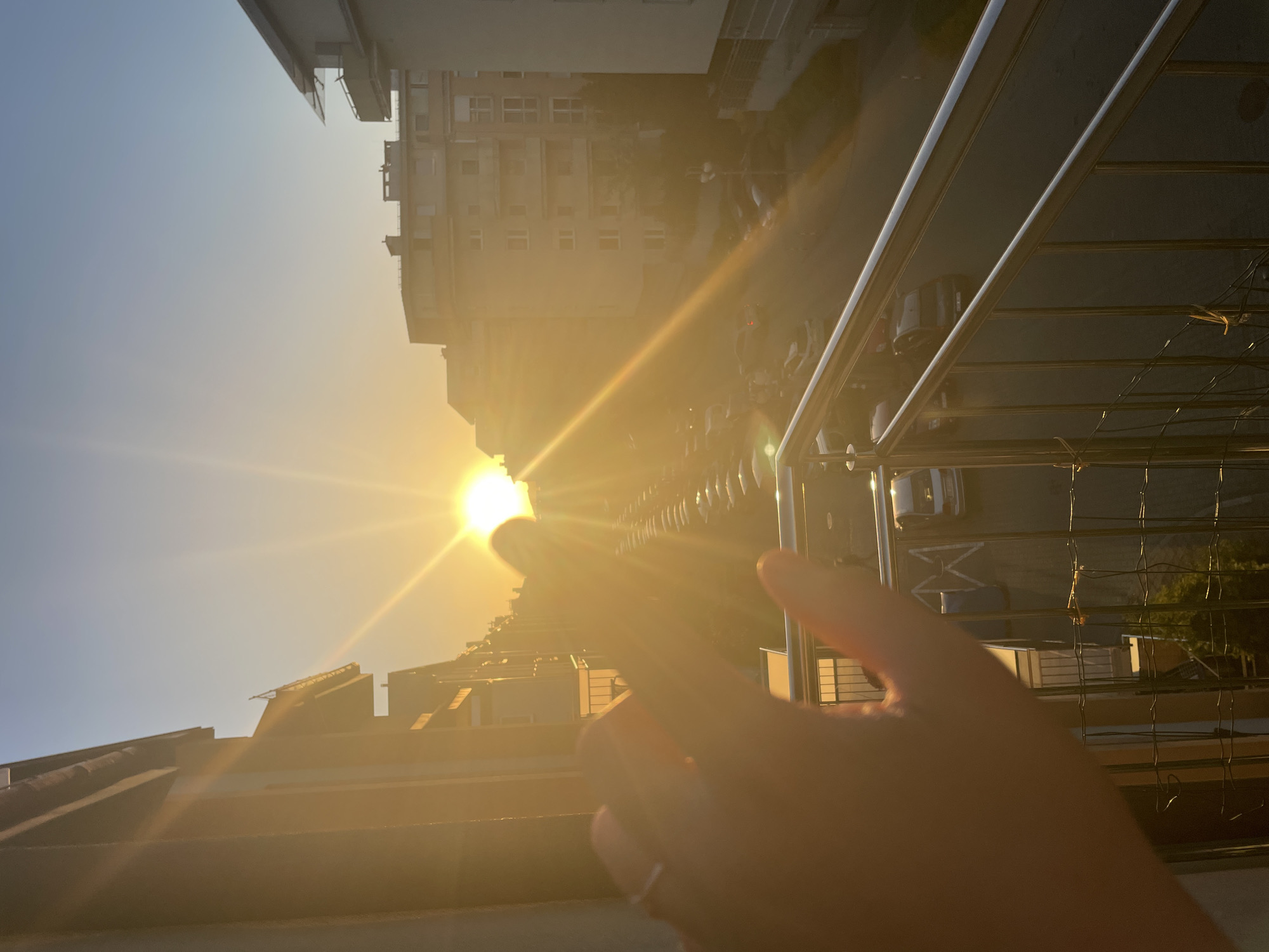 Urban sunset witnessed from multiple elevated viewpoints, hands gesturing skyward