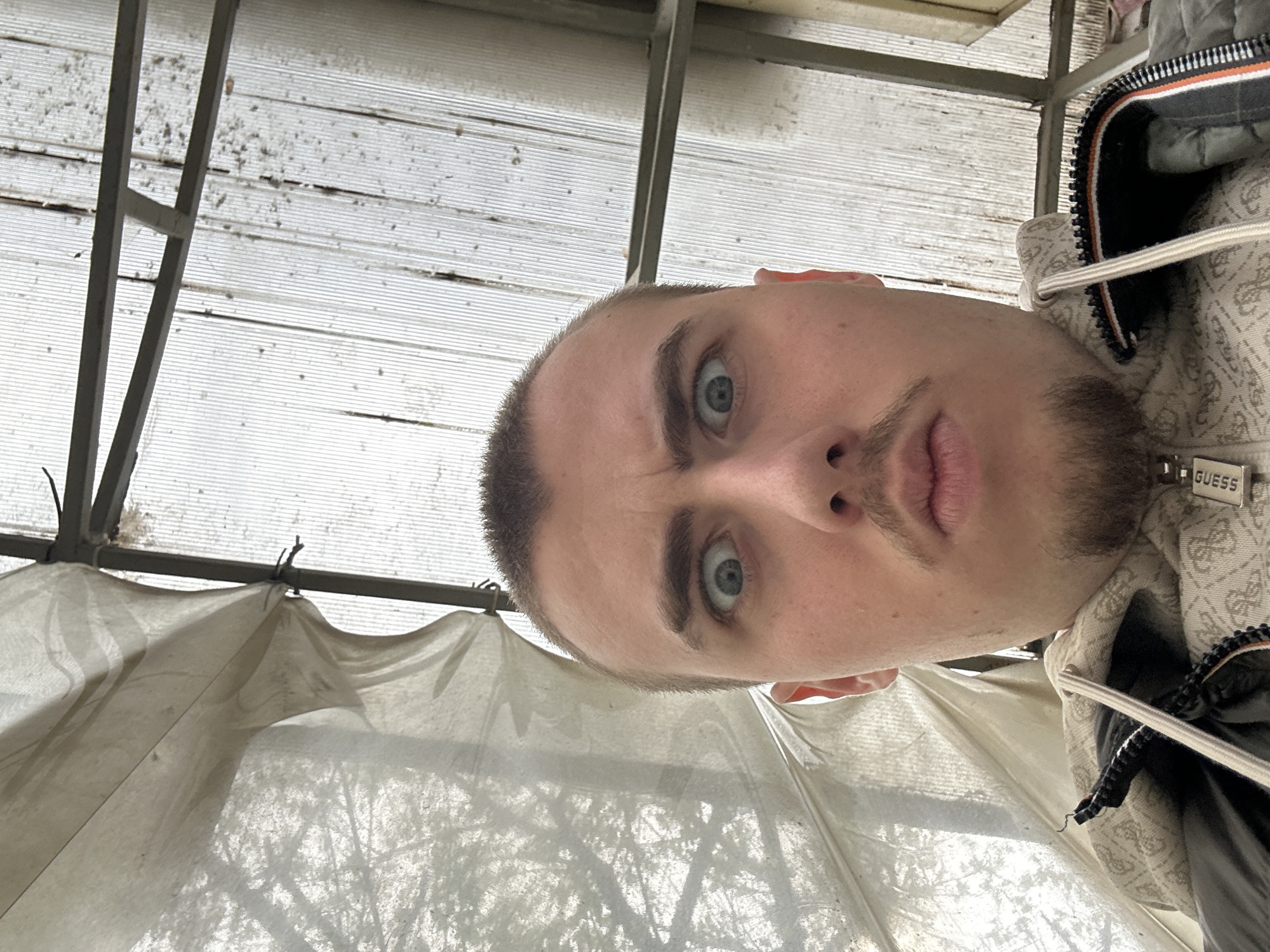 Man takes selfie in Sofia wearing Guess hoodie