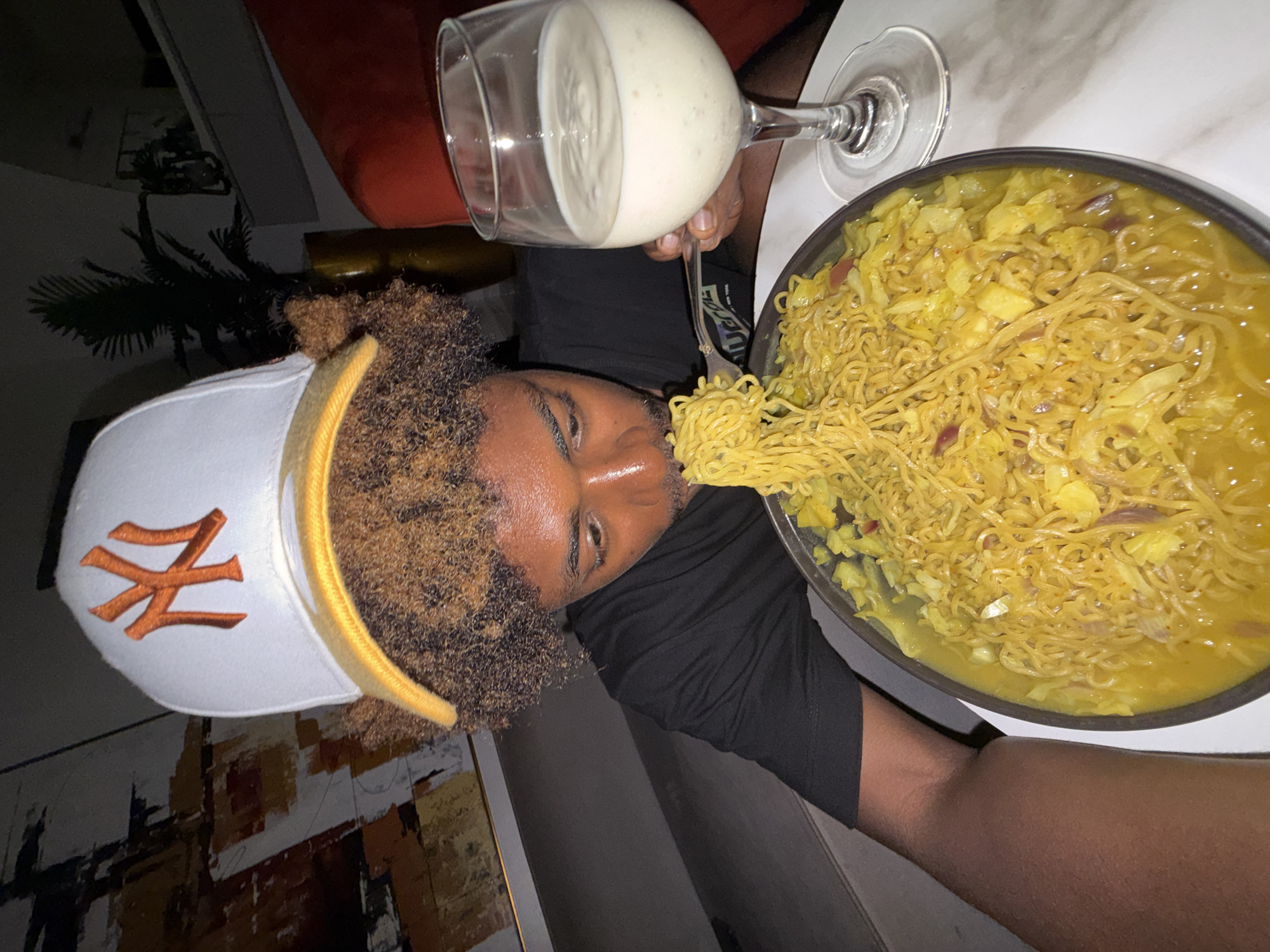 Young man eating noodles documented in Igboefon, Nigeria