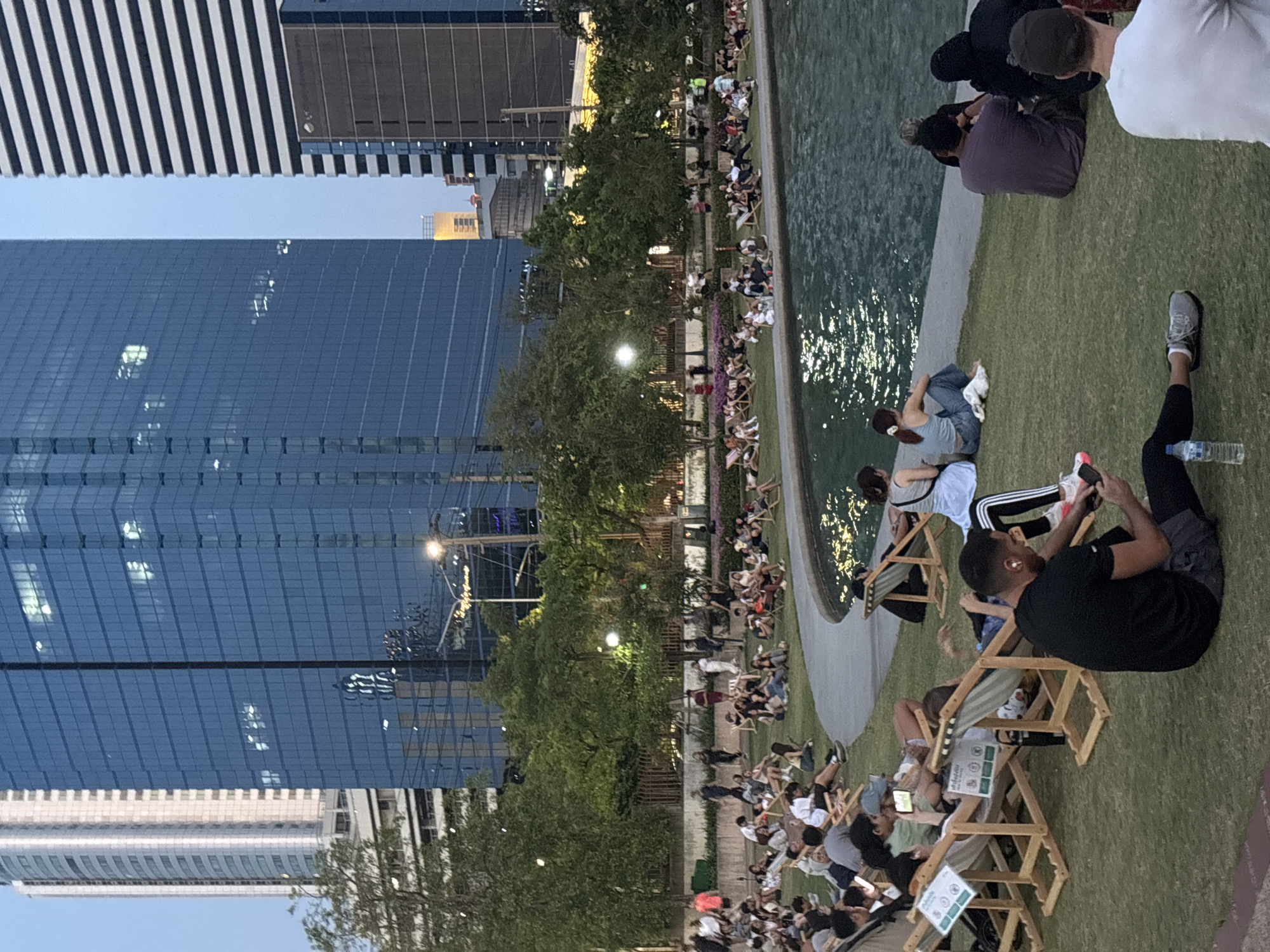 Bangkok residents enjoy routine park activities amid city skyline