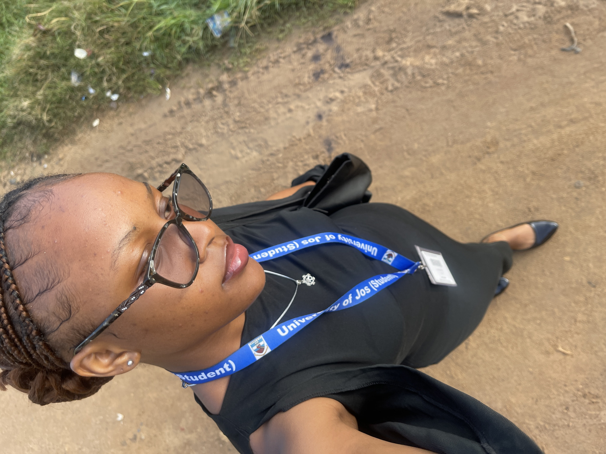 University of Jos student takes selfies on a dirt path in Nigeria