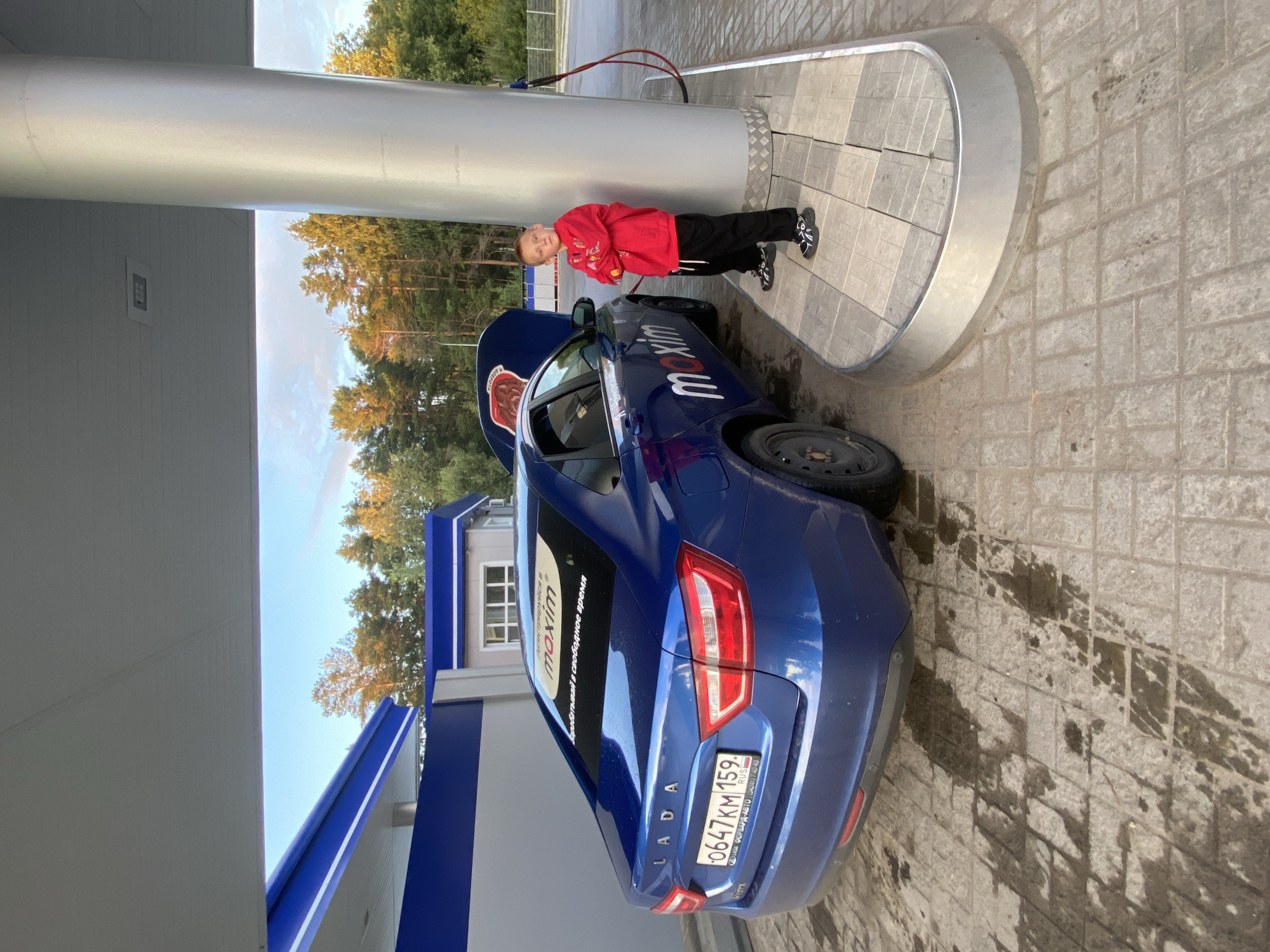 Rainy August evening in Chaikovsky: rainbows, wet roads, a Lada refueling