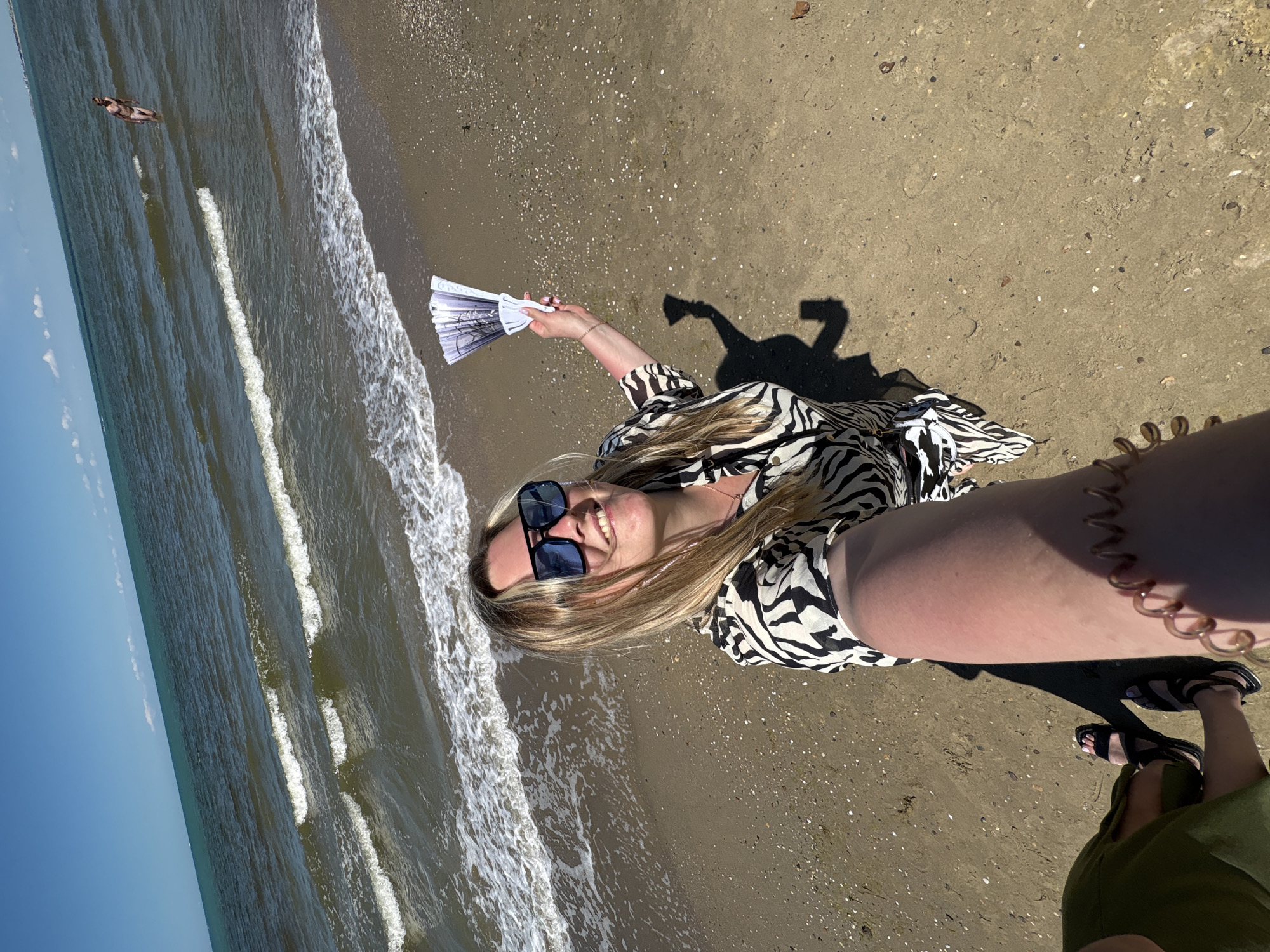 Woman documents sunny morning beach visit in Anapa, Russia