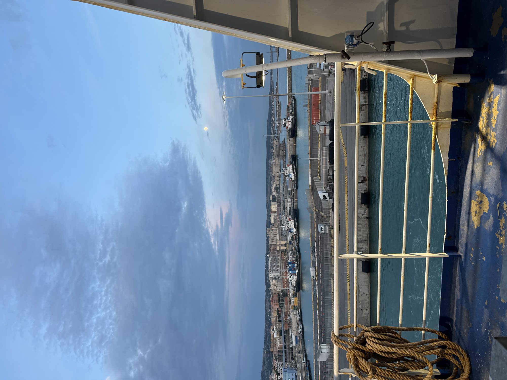 Ferry passengers document evening harbor activity in Civitavecchia