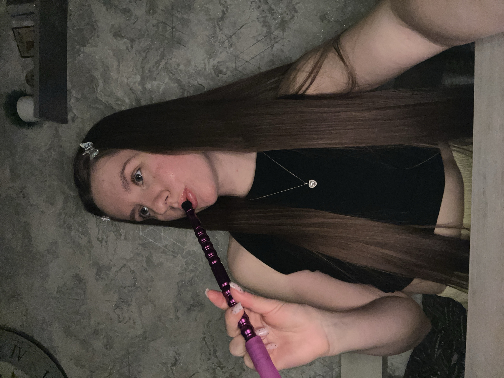 Woman smoking hookah indoors in Klin, Russia