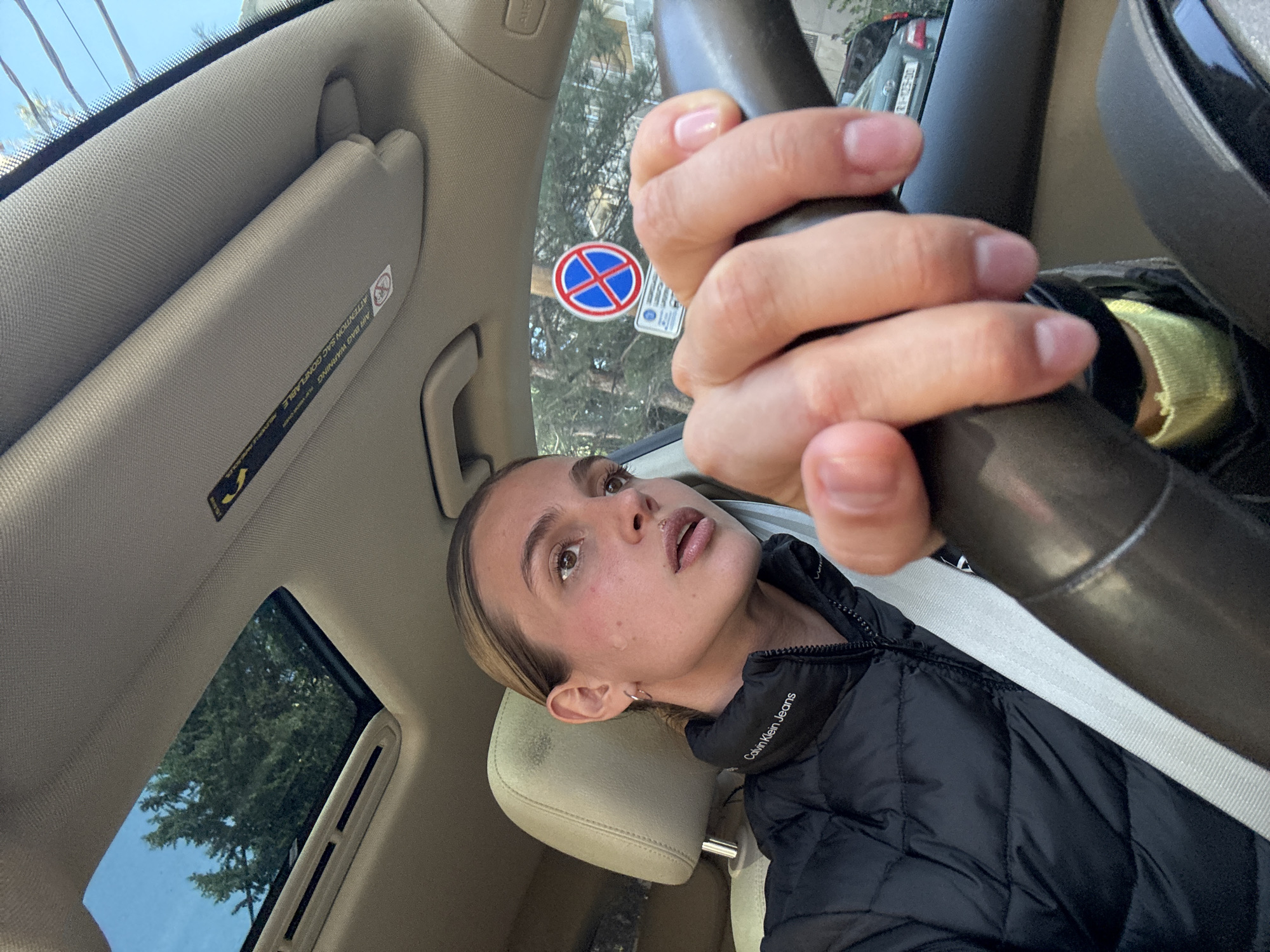 Woman drives car in Tbilisi wearing Calvin Klein jacket