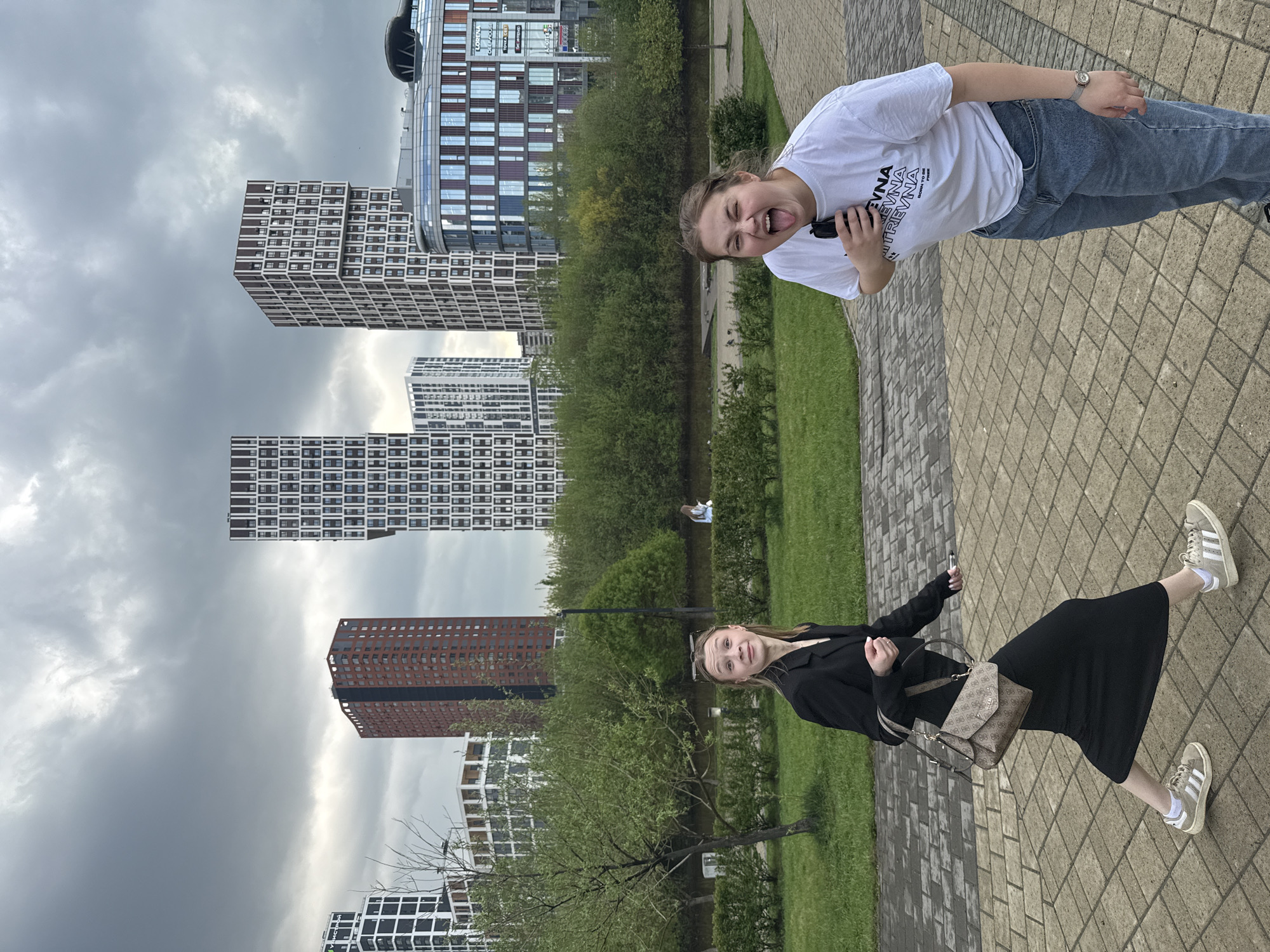 Two women pose playfully on Yekaterinburg walkway
